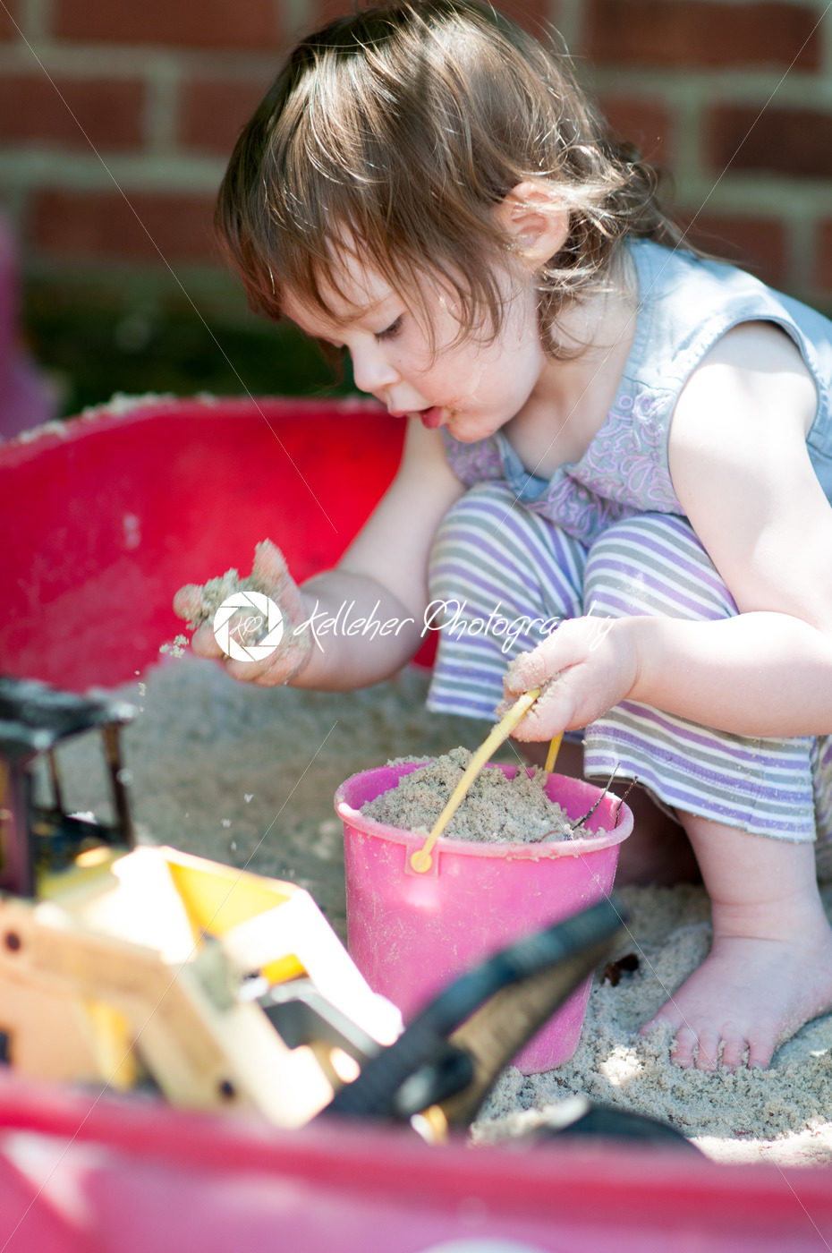 Adorable little girl playing in a sandbox - Kelleher Photography Store