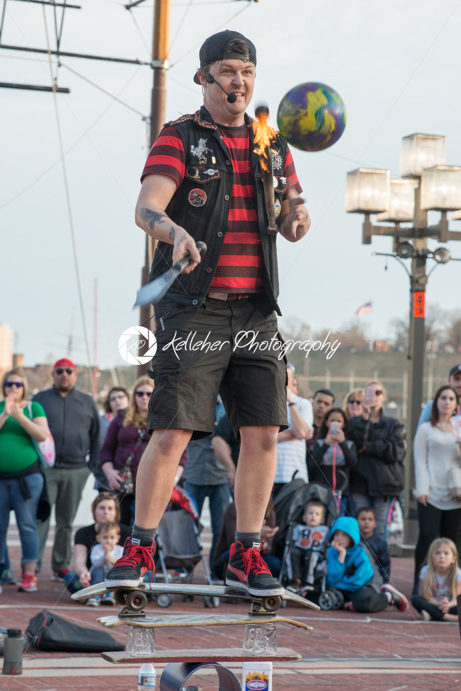 BALTIMORE INNER HARBOR, MD – FEBRUARY 18: Street performer entertains crowd with juggling act on February 18, 2017 - Kelleher Photography Store