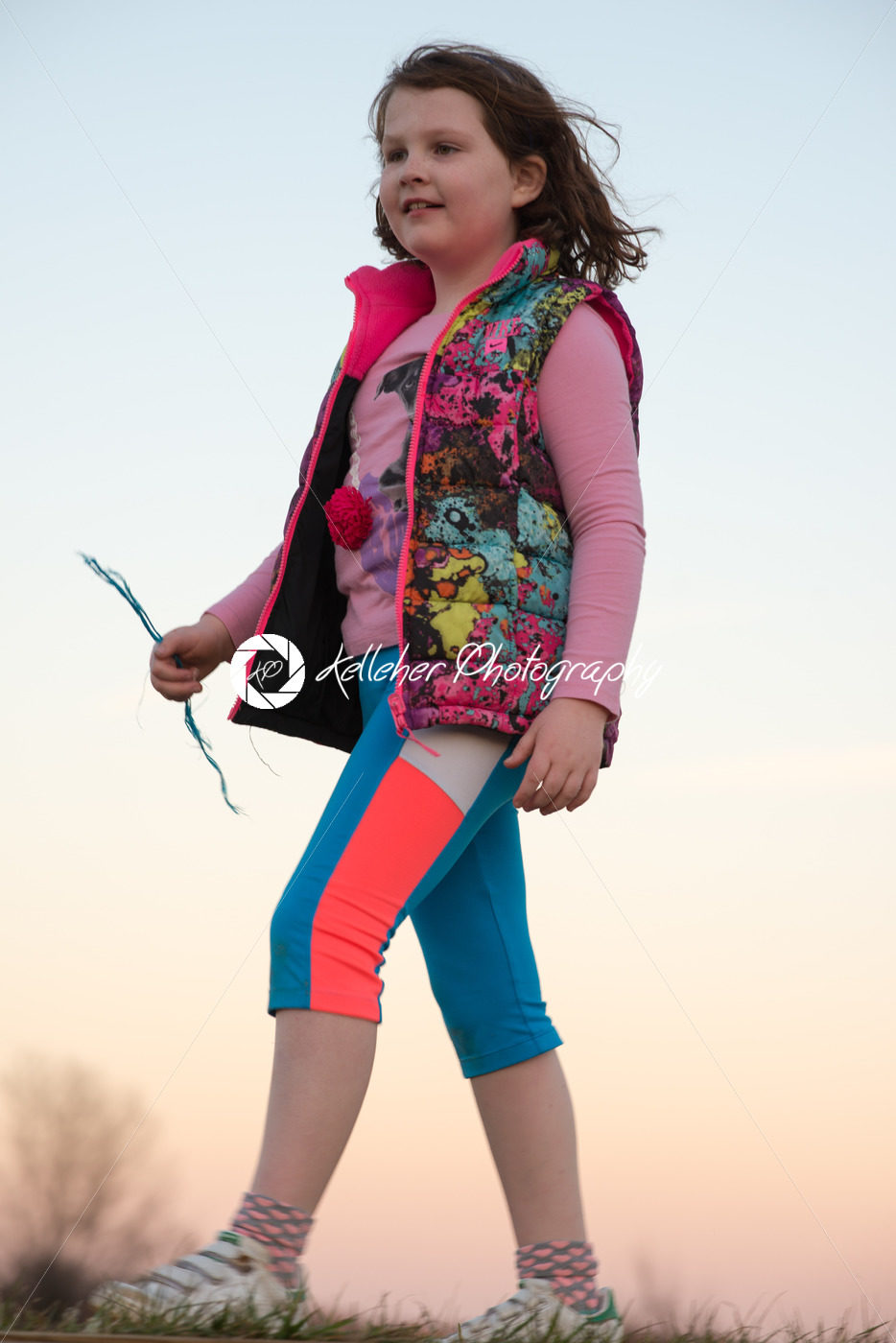 Beautiful young girl outside walking and smiling at sunset golden hour - Kelleher Photography Store