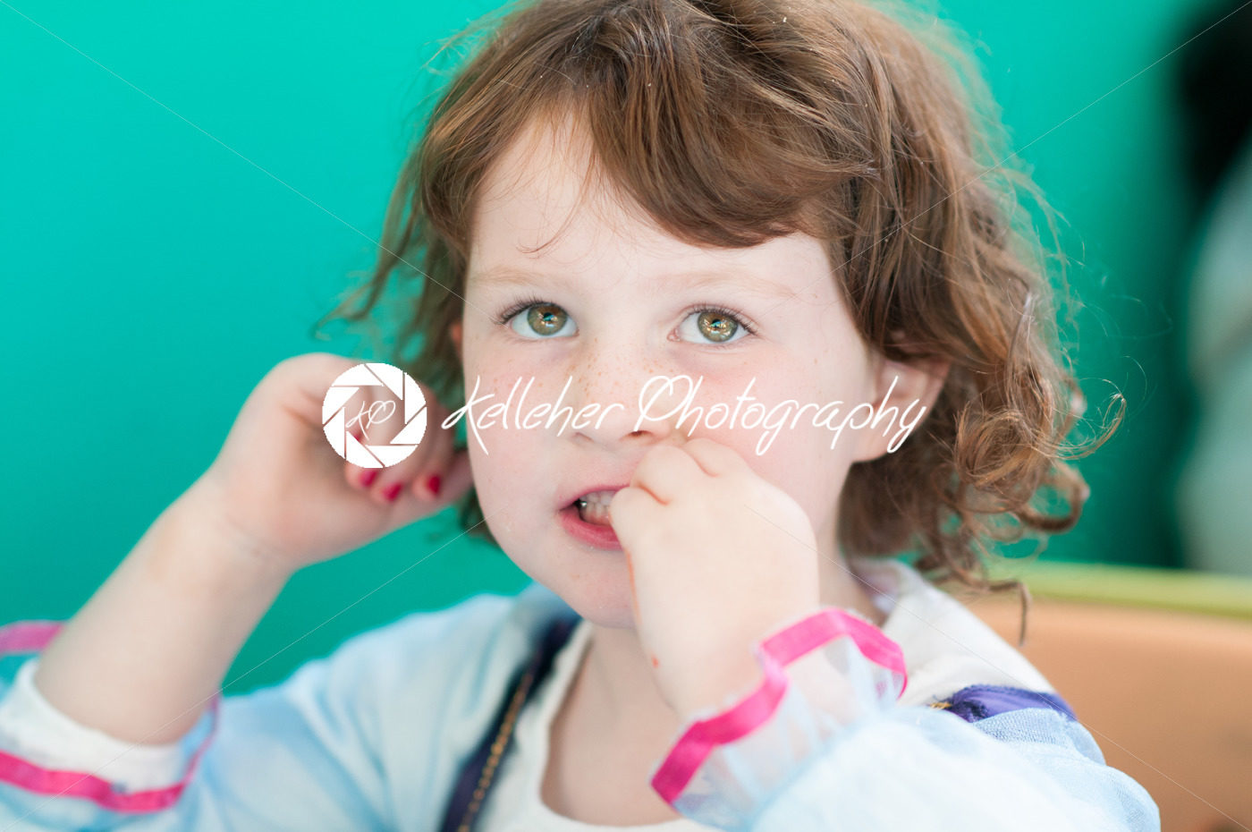 Close up Portrait of young girl eating - Kelleher Photography Store