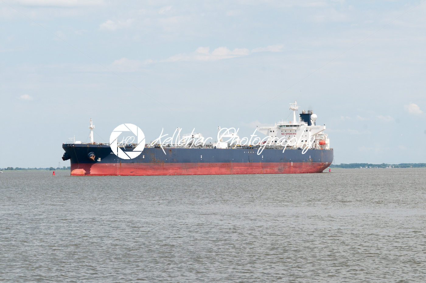 DELAWARE CITY, DE – AUGUST 1: Oil tanker ship coming into port on Delware river on a background of blue sky on August 1, 2015 - Kelleher Photography Store