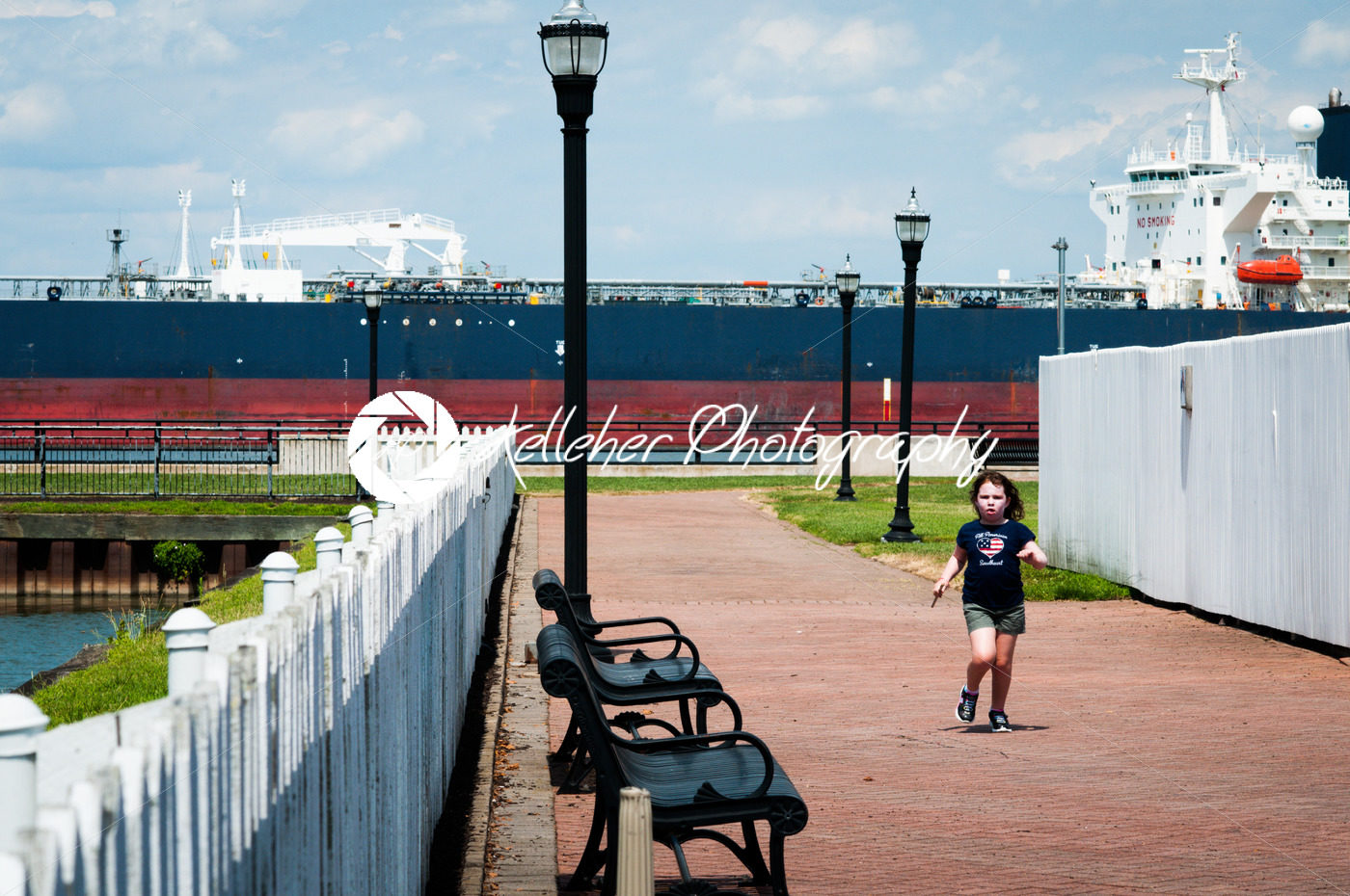 DELAWARE CITY, DE – AUGUST 1: Oil tanker ship coming into port on Delware river on a background of blue sky on August 1, 2015 - Kelleher Photography Store