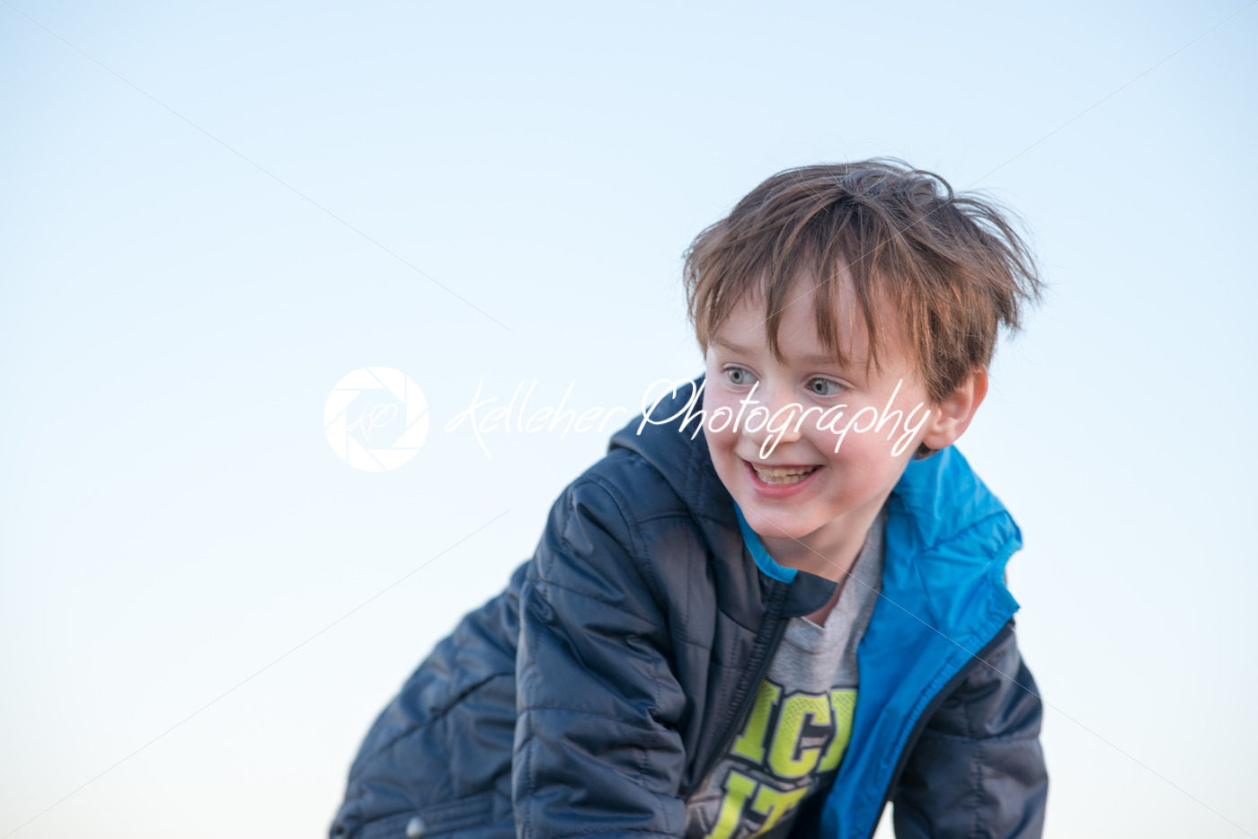 Handsome young boy outside smiling at sunset golden hour - Kelleher Photography Store