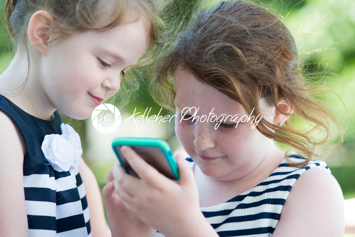 Happy Laughing Children Playing with Smartphone Outside - Kelleher Photography Store