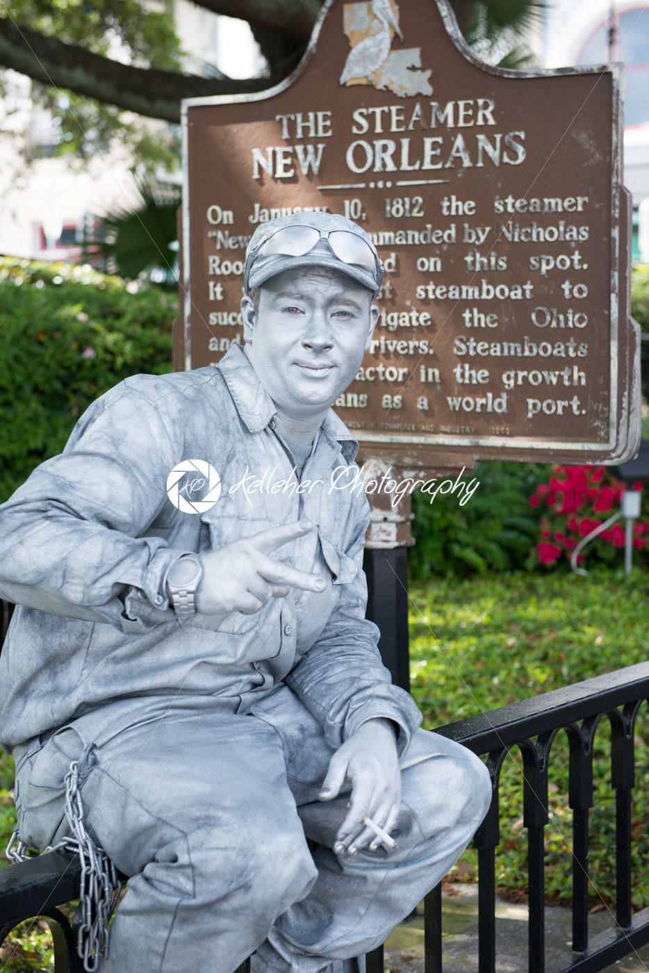 NEW ORLEANS, LA – APRIL 13: Street actor dressed up as a tin man in front of the Steamer historical sign on April 13, 2014 - Kelleher Photography Store