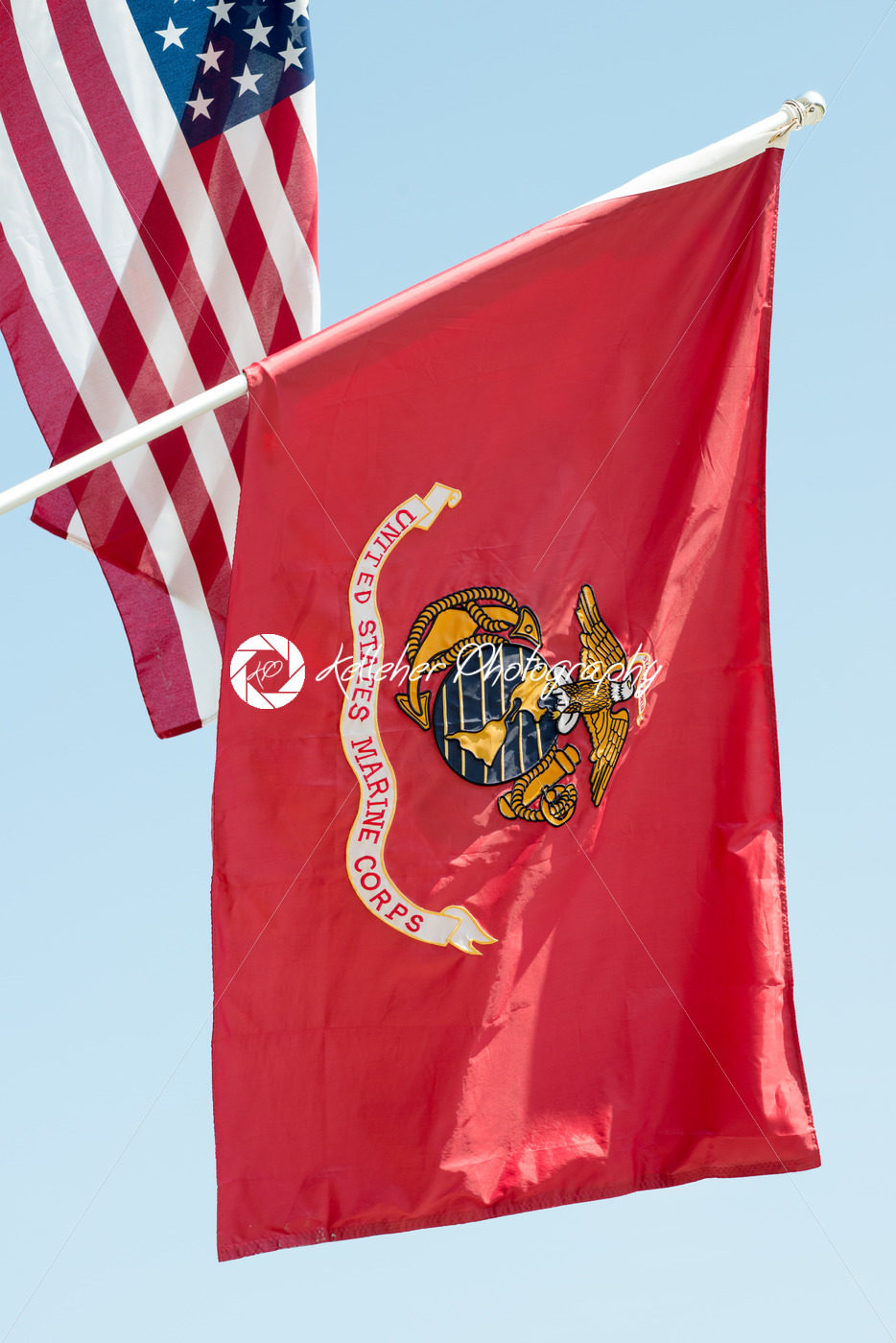 United States Marine Corps flag waving on blue sky background, close up, with American flag in background - Kelleher Photography Store
