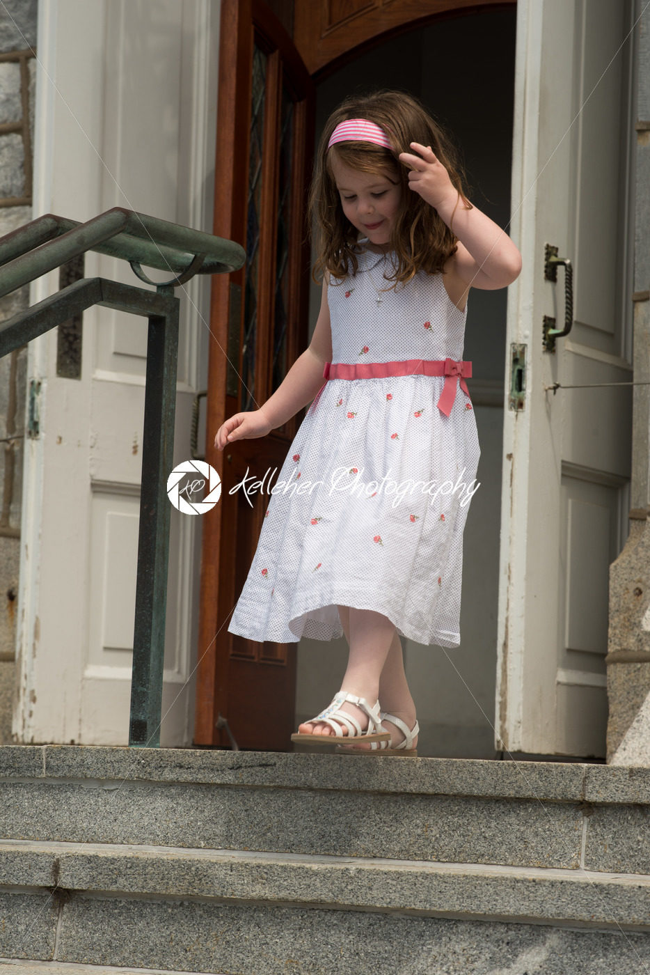 VILLANOVA, PA – MAY 14: Young Girl dressed up receiving her First Holy Communion at St. Thomas of Villanova Church - Kelleher Photography Store