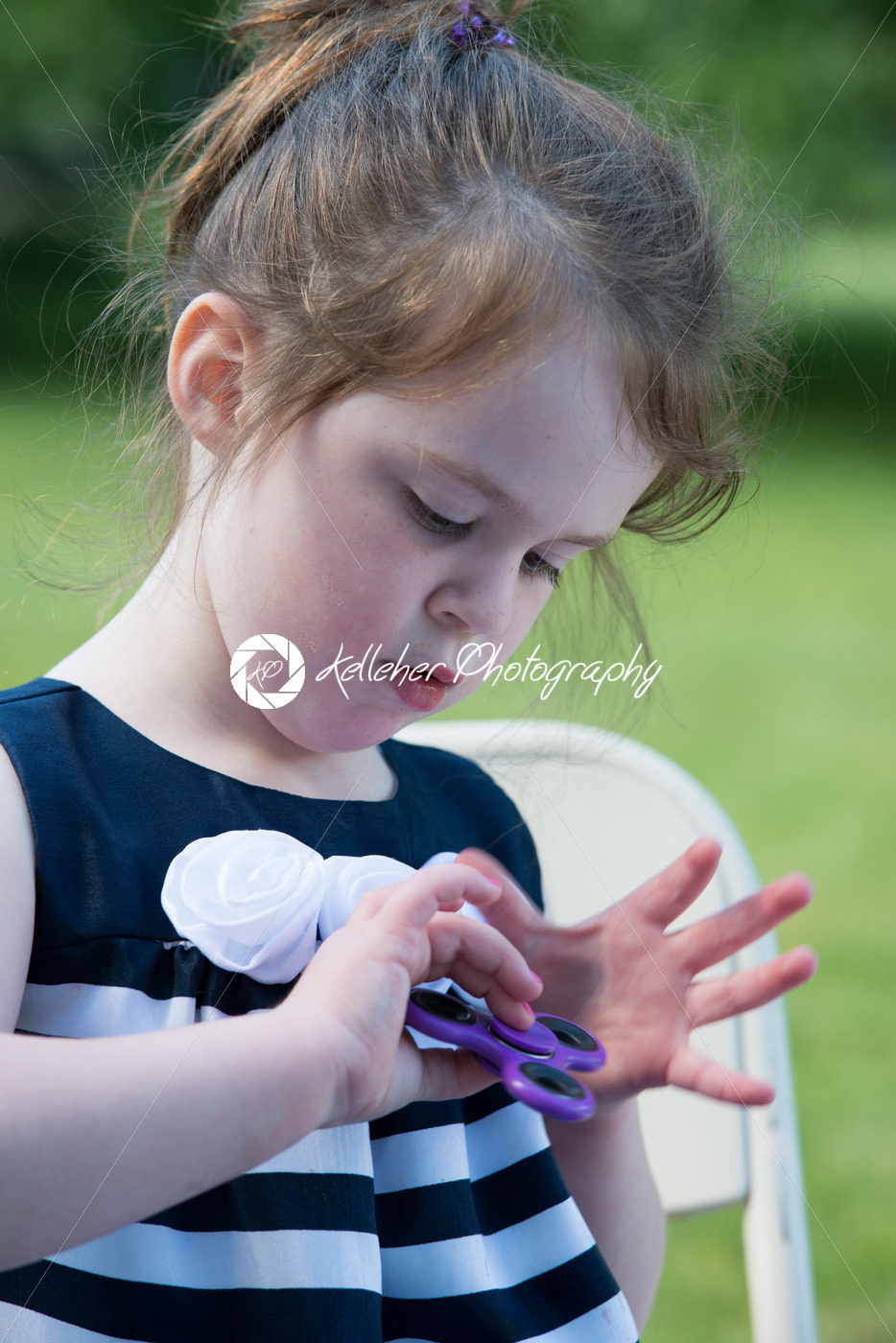 Young Girl Playing with Fidget Hand Spinner - Kelleher Photography Store