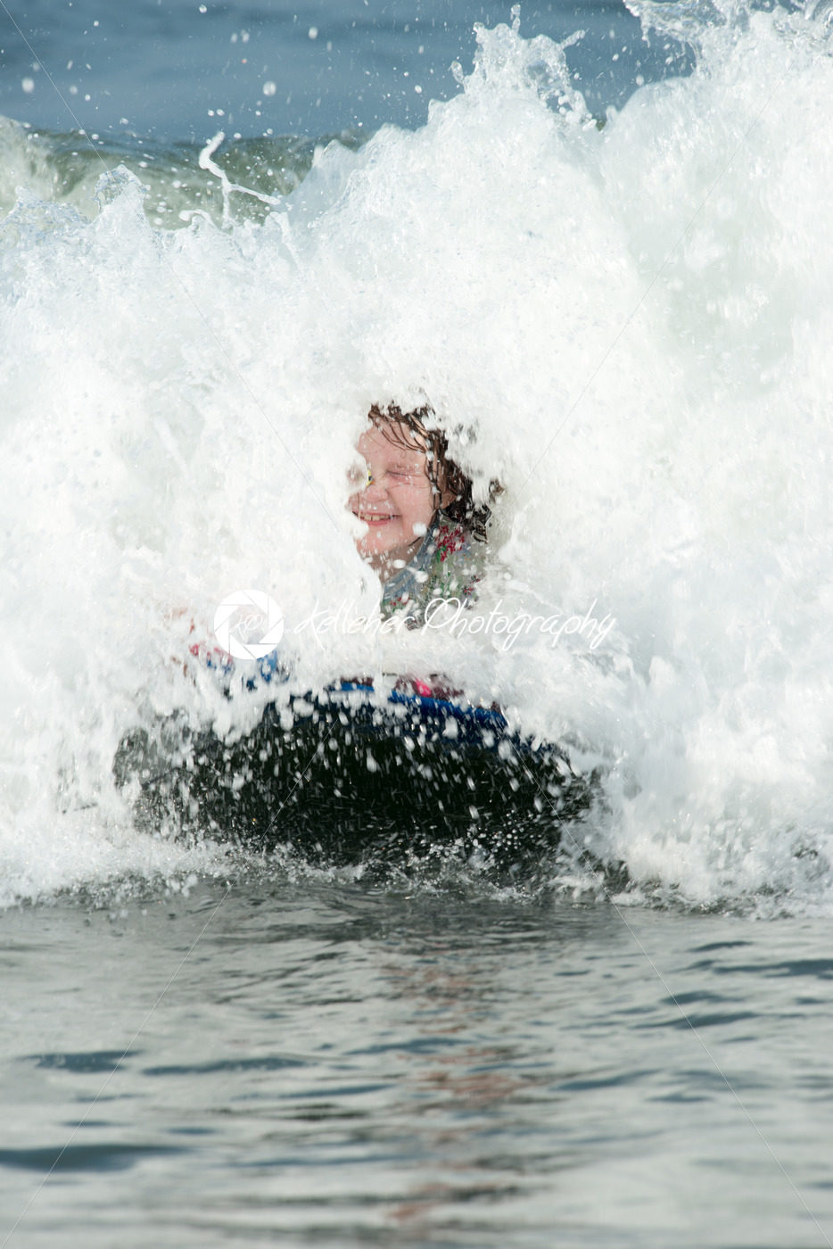 Young Girl surfing the waves on a boogy board - Kelleher Photography Store