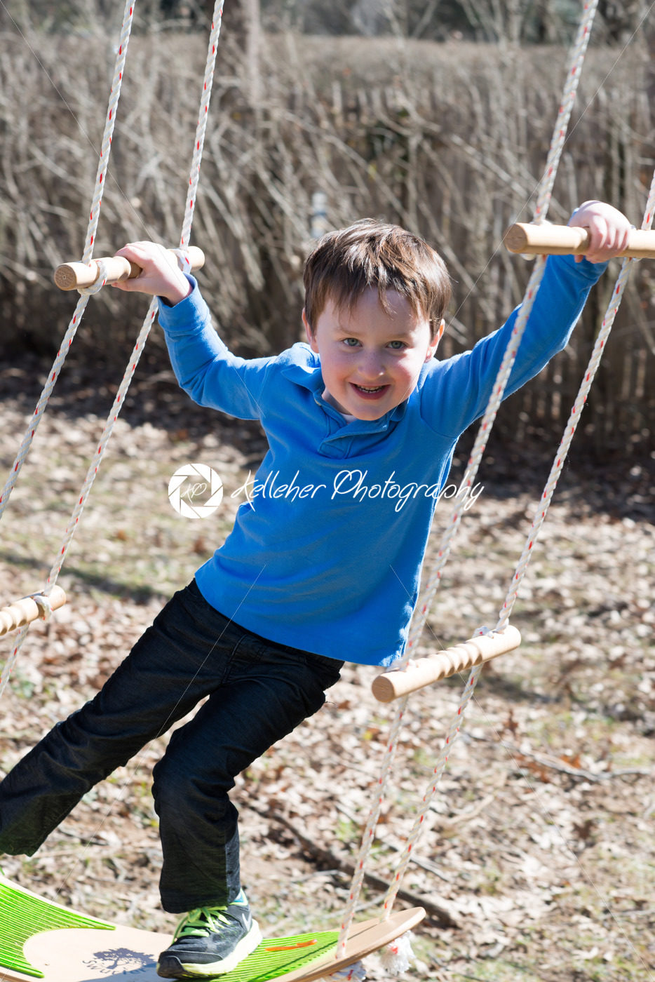 Young boy outside in backyard having fun on a swing - Kelleher Photography Store