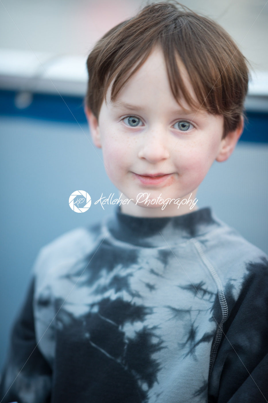 Young boy outside on boat looking happy - Kelleher Photography Store