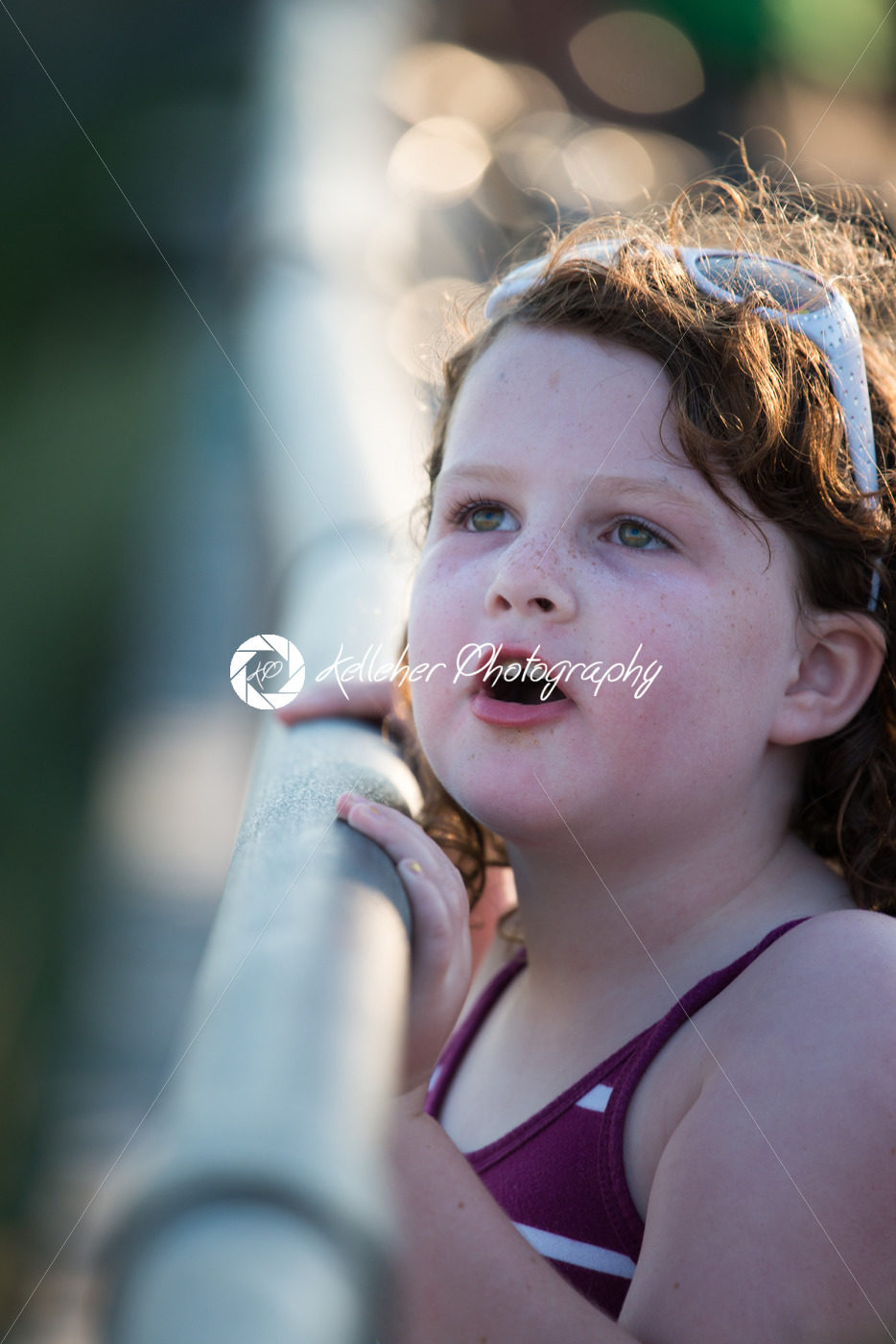 Young cute little girl on the boardwalk looking up - Kelleher Photography Store