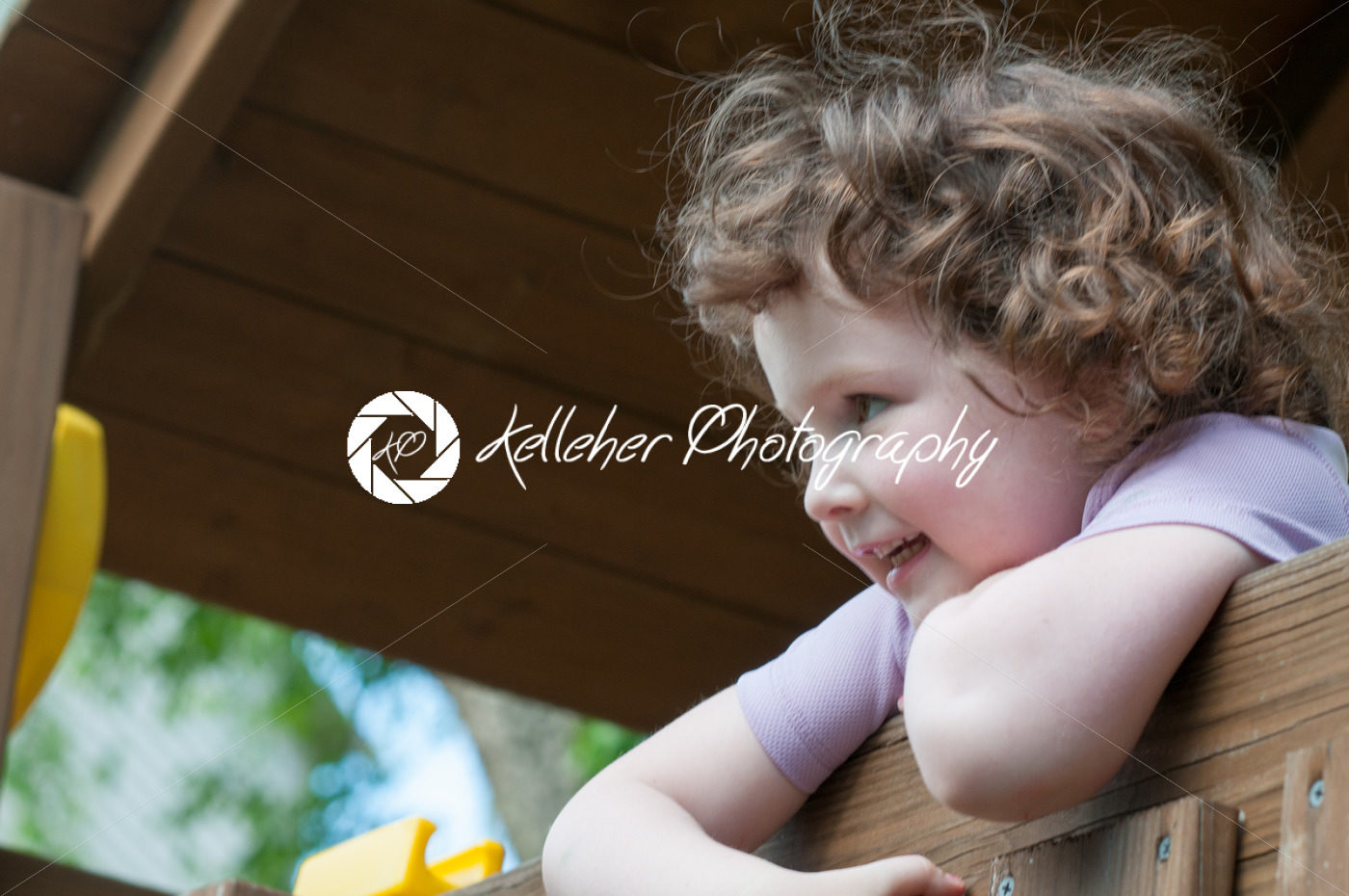 Young girl having fun on a swing set - Kelleher Photography Store