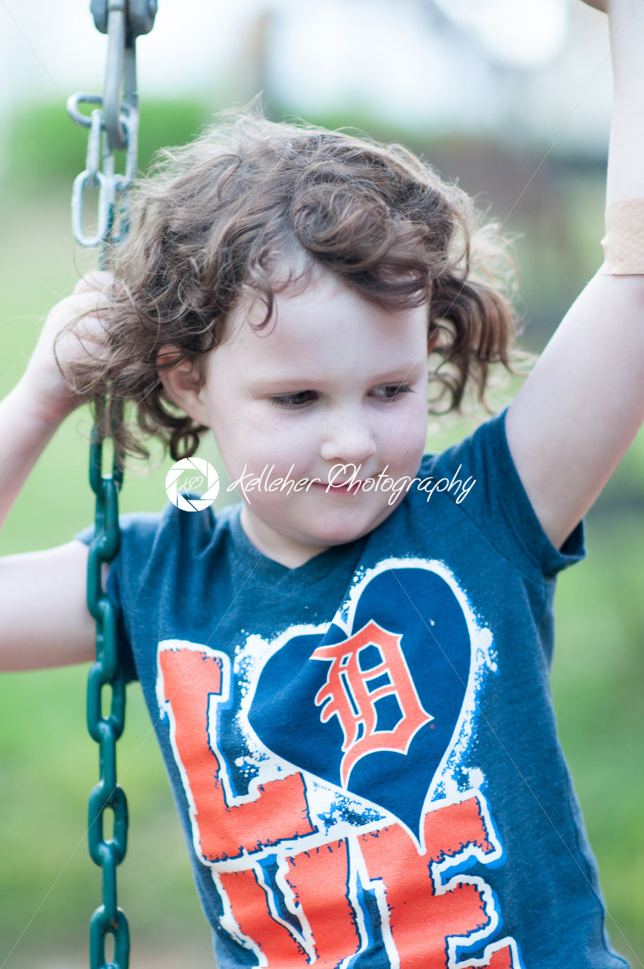 Young girl having fun on a swing set - Kelleher Photography Store
