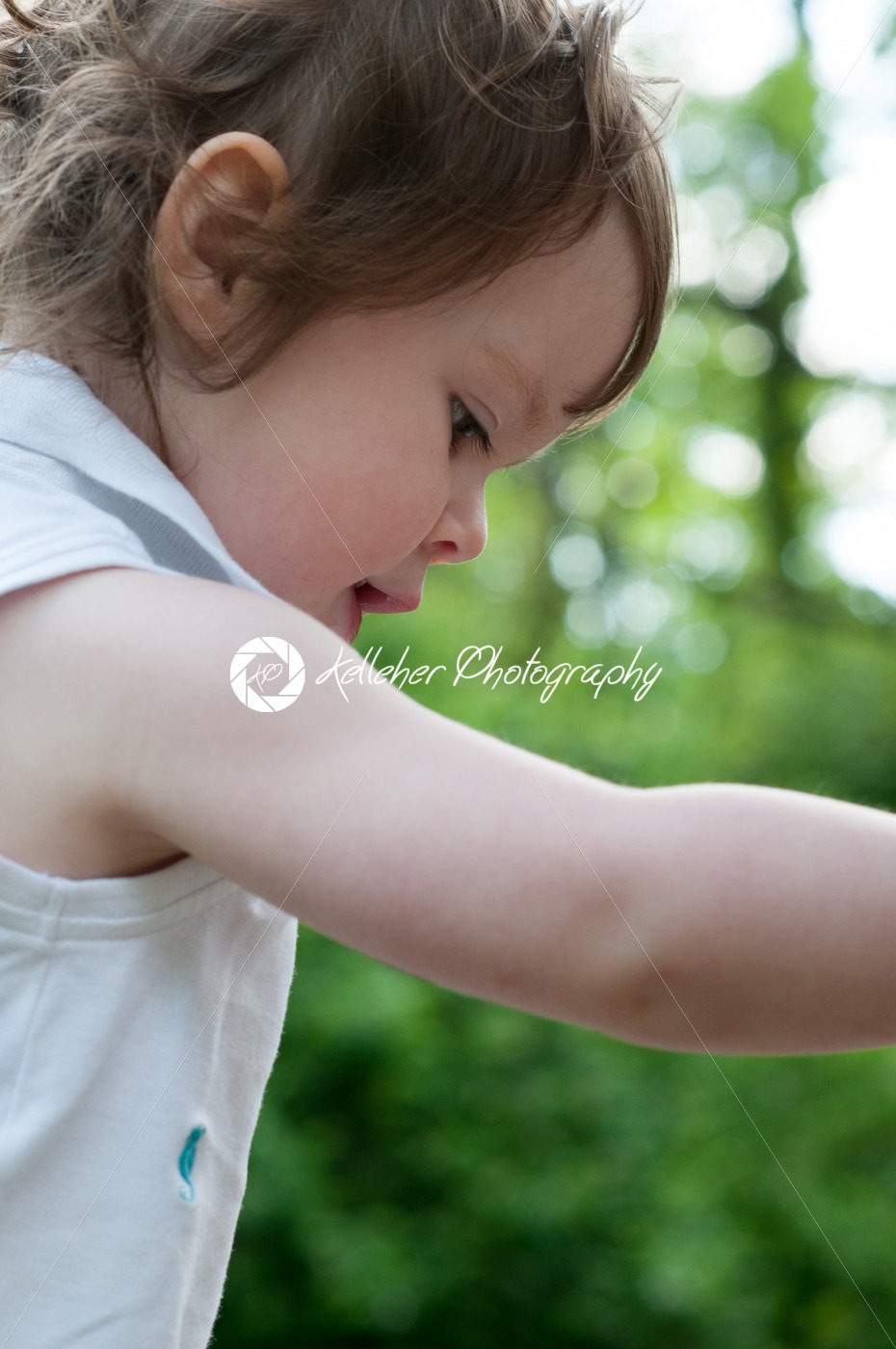 Young girl having fun outdoors in the back yard - Kelleher Photography Store