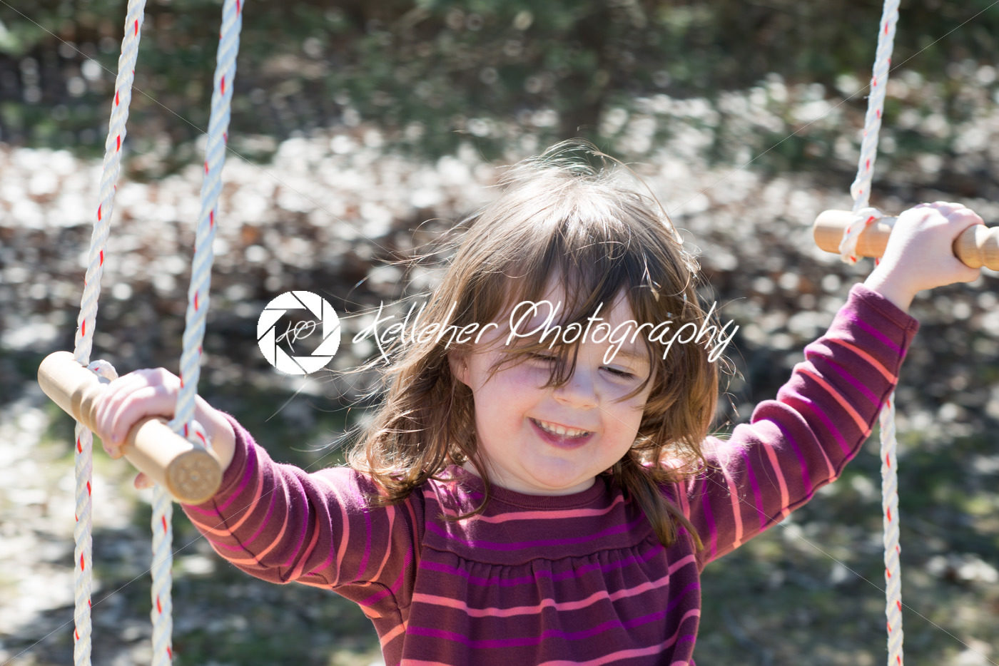 Young girl outside in backyard having fun on a swing - Kelleher Photography Store