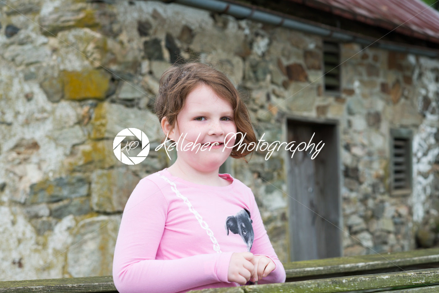 Young girl outside standing in front of an old brick farm house - Kelleher Photography Store