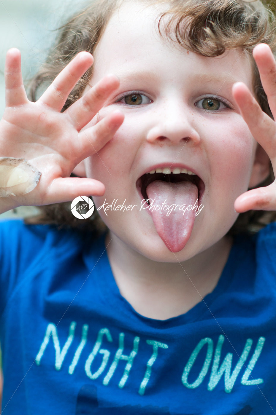 Young girl outside sticking out her tongue - Kelleher Photography Store
