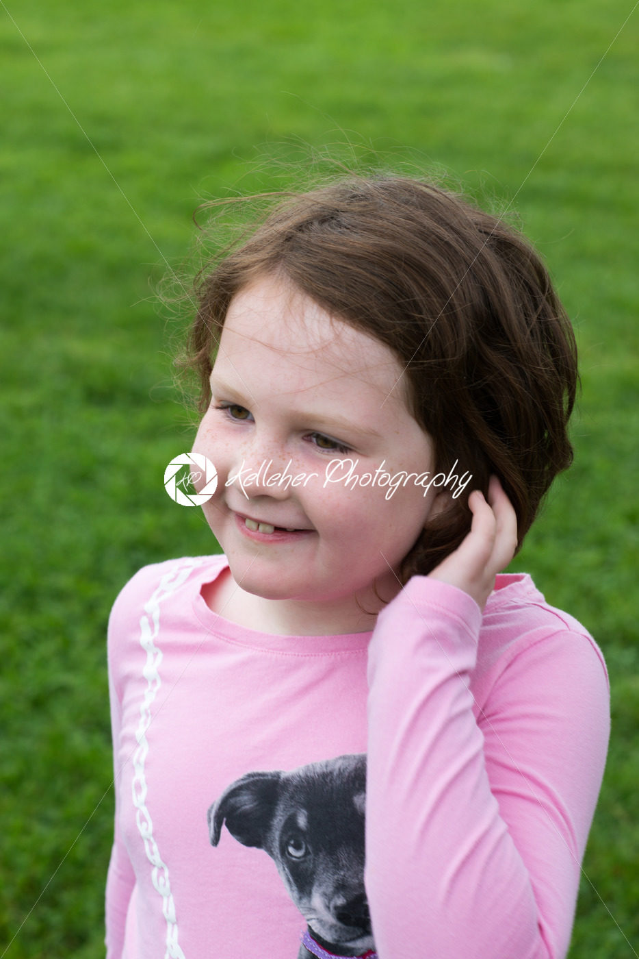 Young girl outside with hand in her hair - Kelleher Photography Store