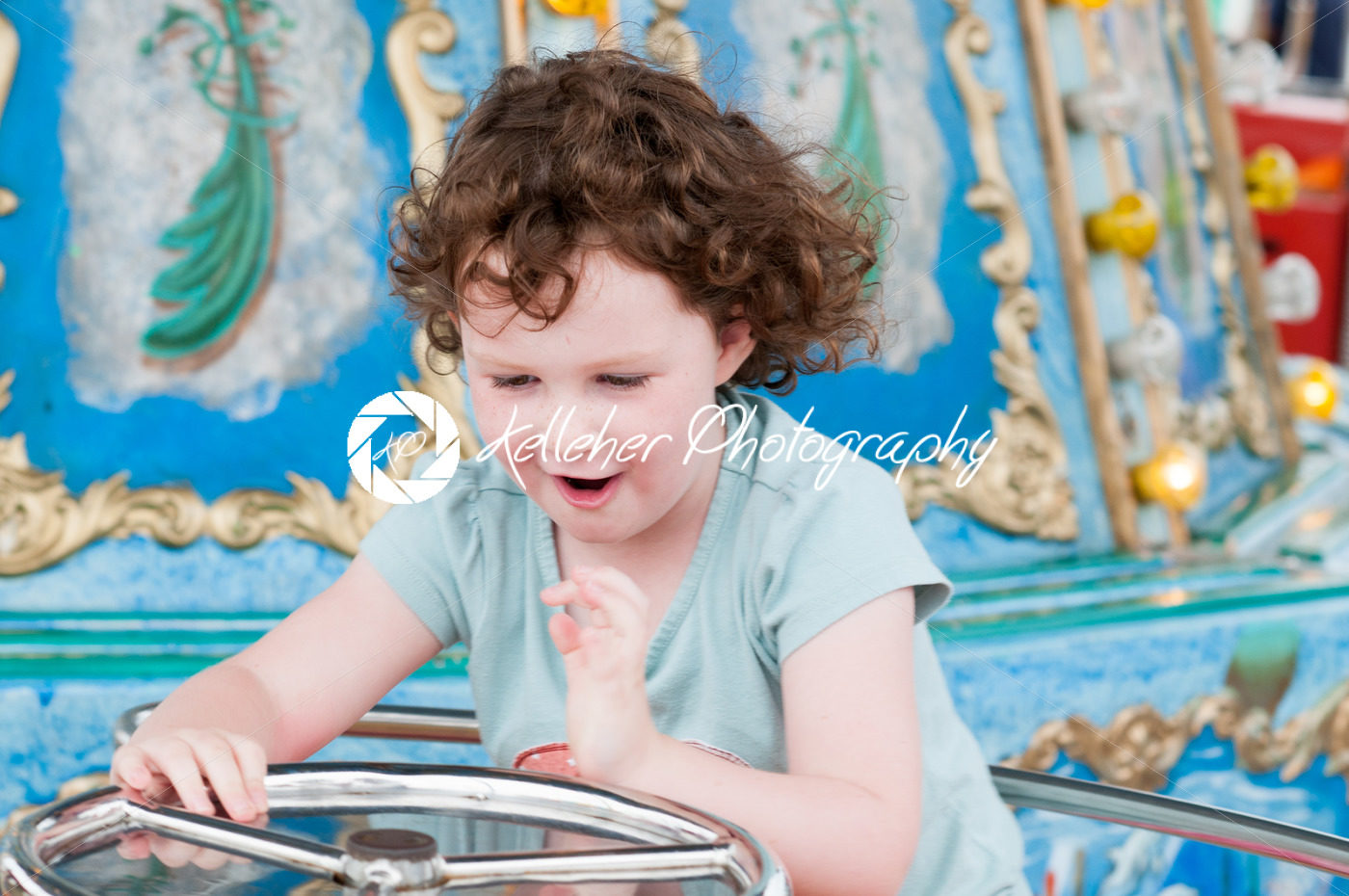 Young toddler girl having fun on boardwalk amusement ride - Kelleher Photography Store