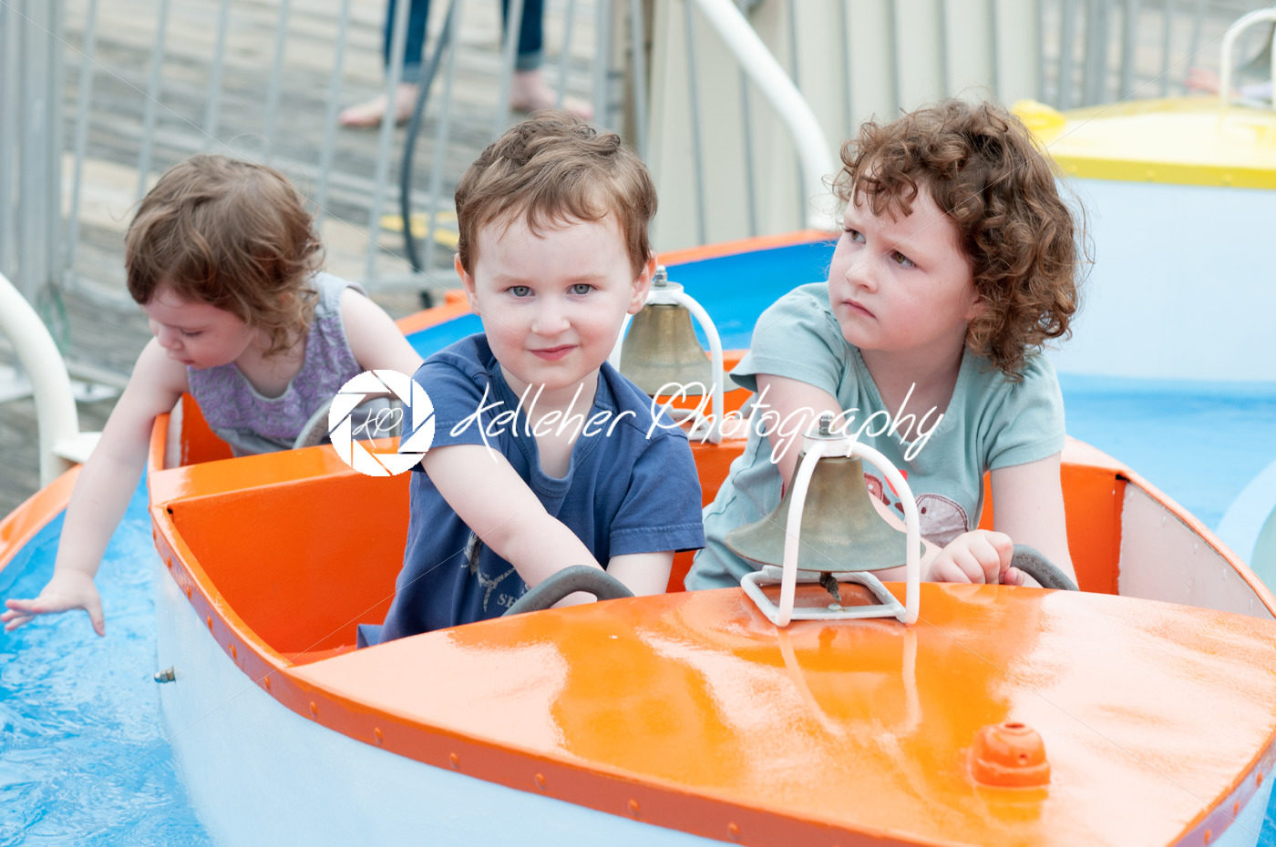 Young toddler sibblings having fun on boardwalk amusement ride - Kelleher Photography Store