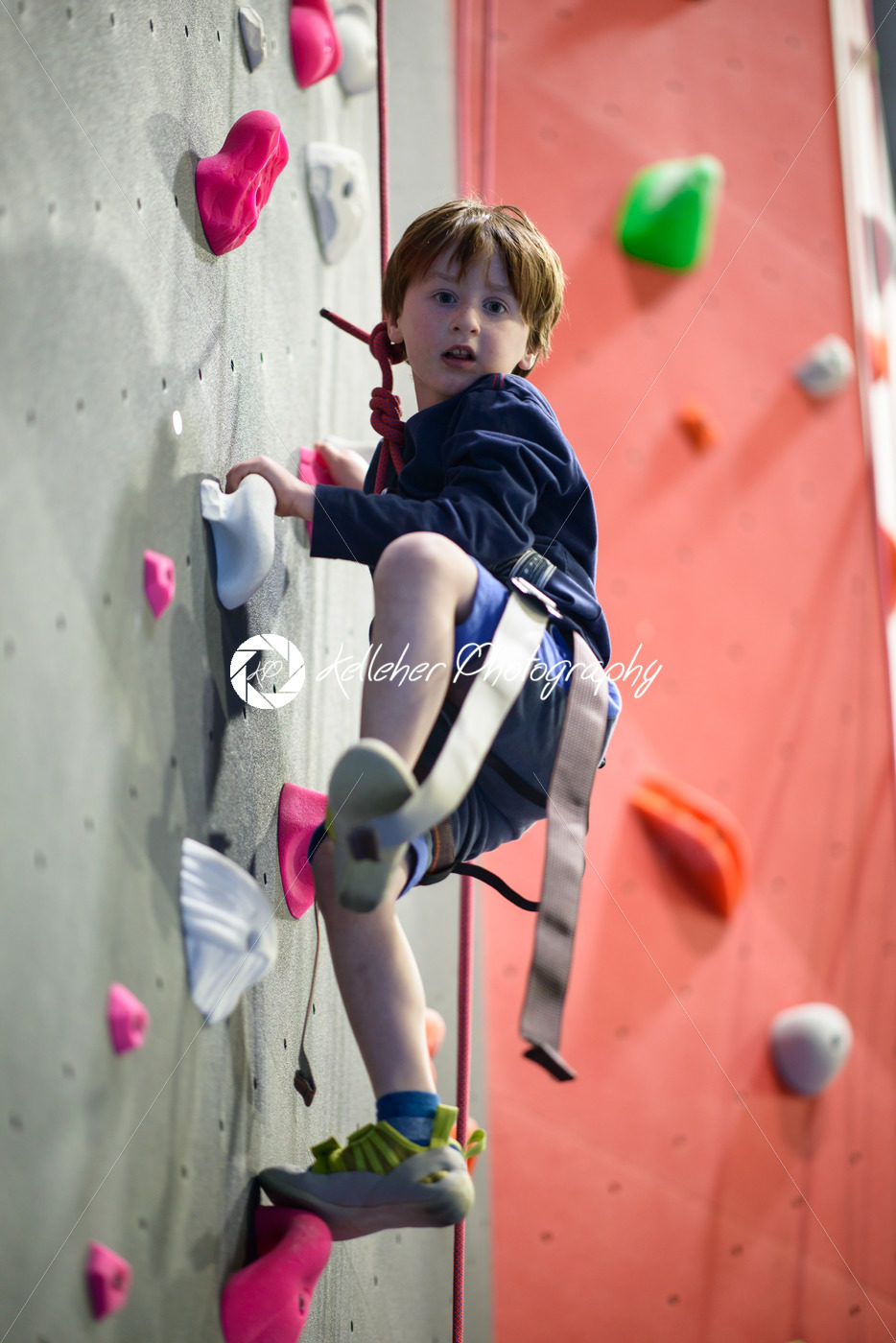 little boy climbing a rock wall indoor - Kelleher Photography Store