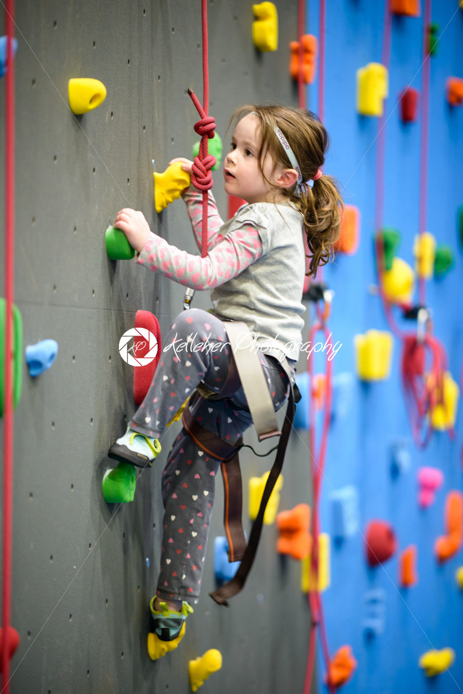 little girl climbing a rock wall indoor - Kelleher Photography Store