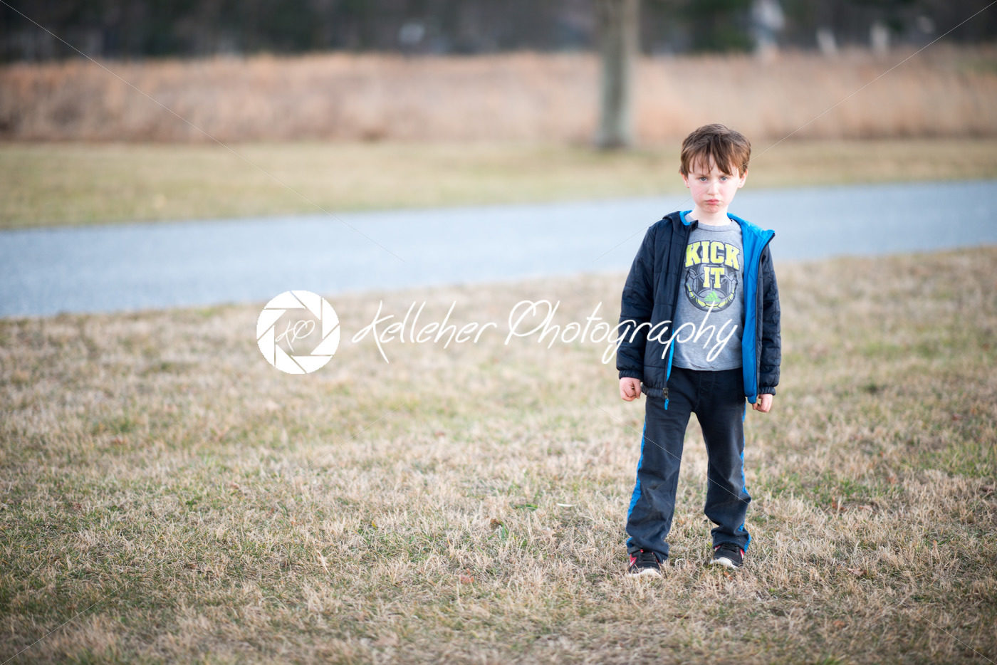 young boy outside pouting and angry at sunset golden hour - Kelleher Photography Store