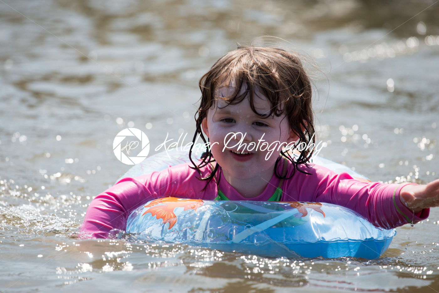 young girl floating in inner tubes in a blissful state - Kelleher Photography Store