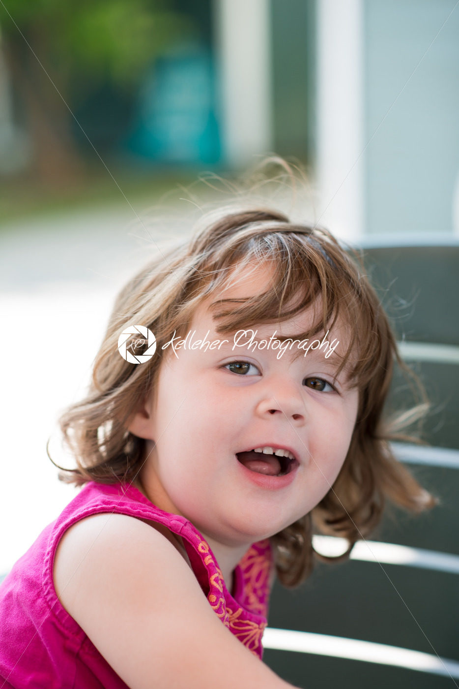 young little girl sitting down and looking happy - Kelleher Photography Store