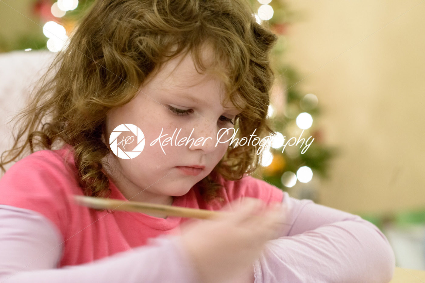 Cute little child girl writes the letter to Santa Claus near Christmas tree indoors. - Kelleher Photography Store