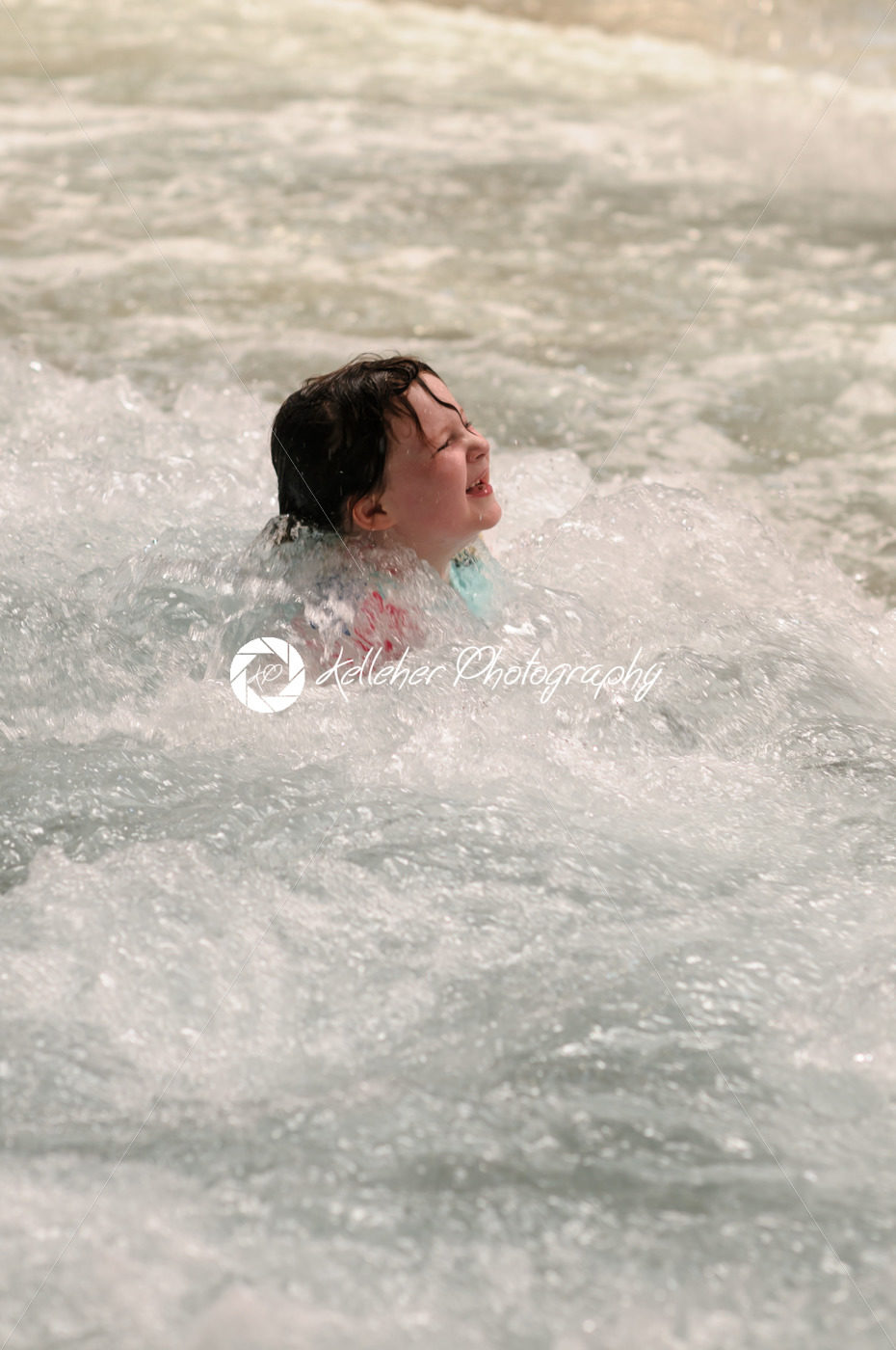 Little girl swimming indoors in big sport wave pool. - Kelleher Photography Store