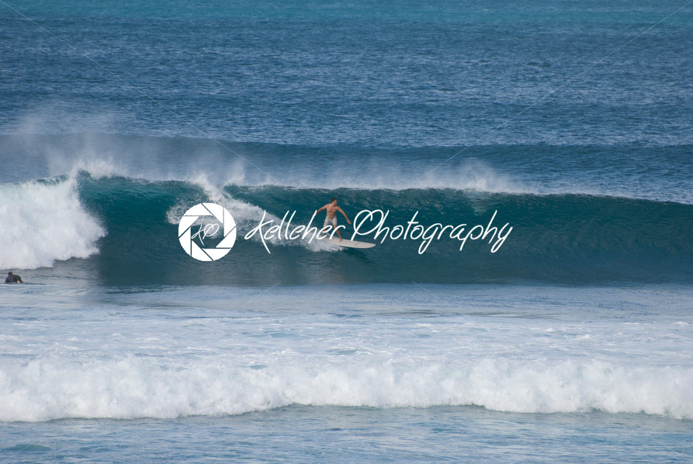 MAUI, HI – DECEMBER 8: Surfers ride a big waves in Maui on December 8, 2007 - Kelleher Photography Store