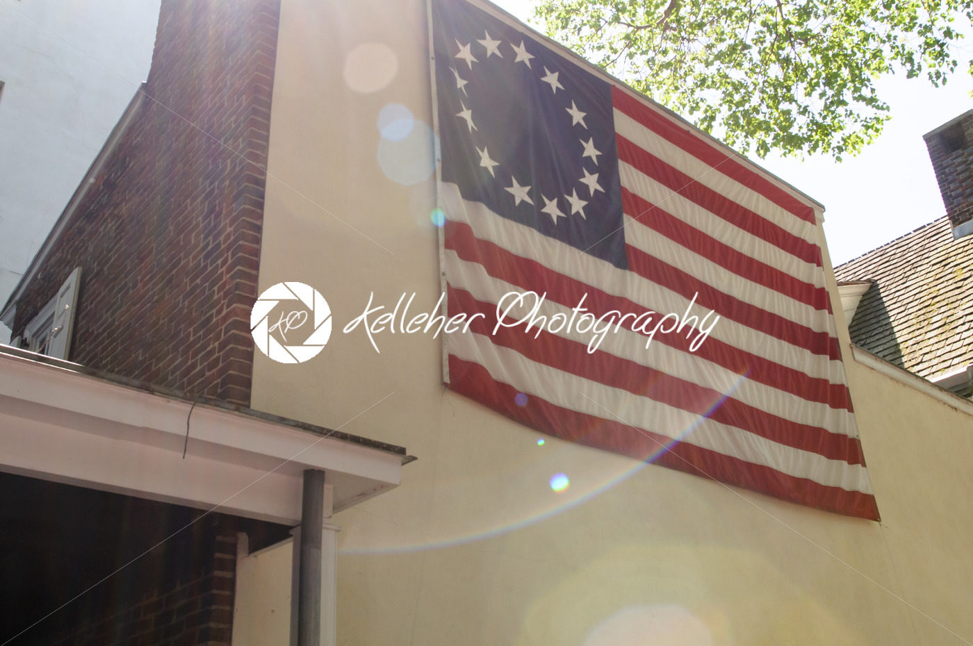 PHILADELPHIA, PA – MAY 14: American thirteen point historic flag often named the Betsy Ross flag, in front of the Betsy Ross House at 239 Arch Street on May 14, 2015 - Kelleher Photography Store