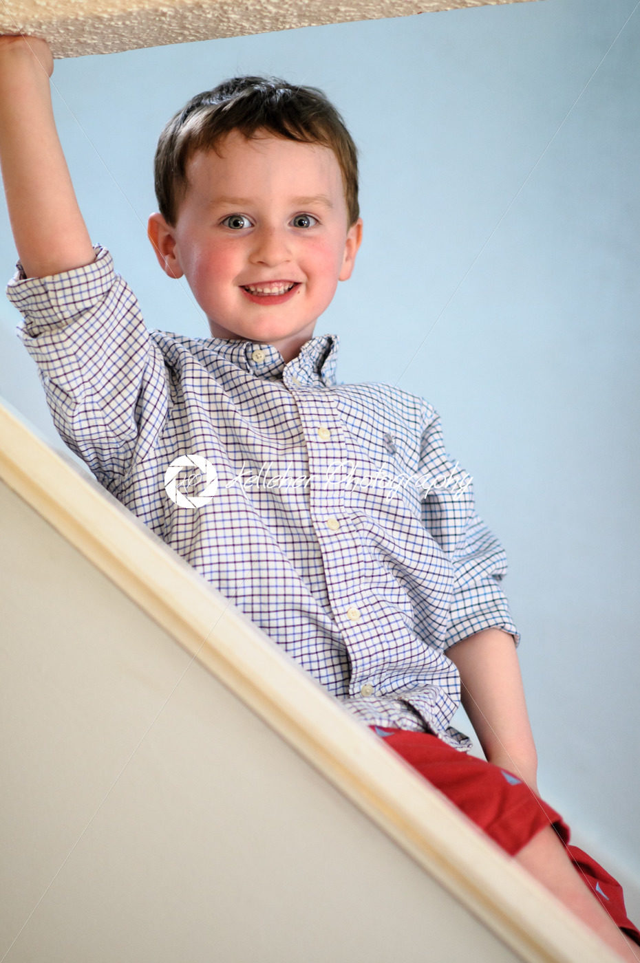 Portrait of a cute little boy inside on stairs - Kelleher Photography Store