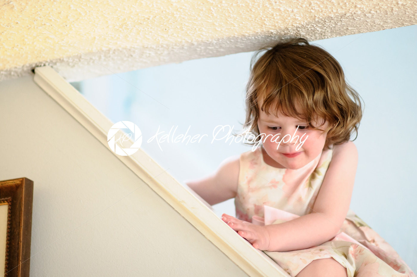 Portrait of a cute little girl inside on stairs - Kelleher Photography Store