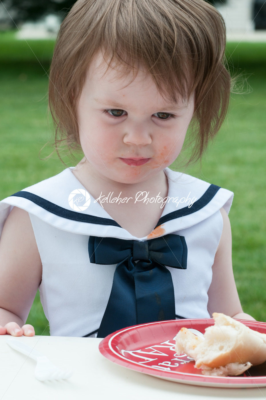Young girl in fancy dress outside eating - Kelleher Photography Store