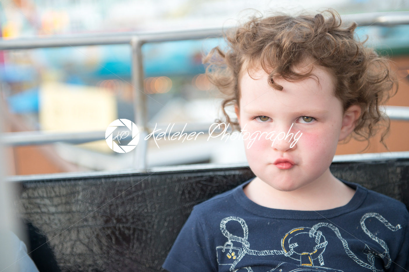 Young girl on boardwalk amusement ride ferris wheel with pouting expression on face - Kelleher Photography Store