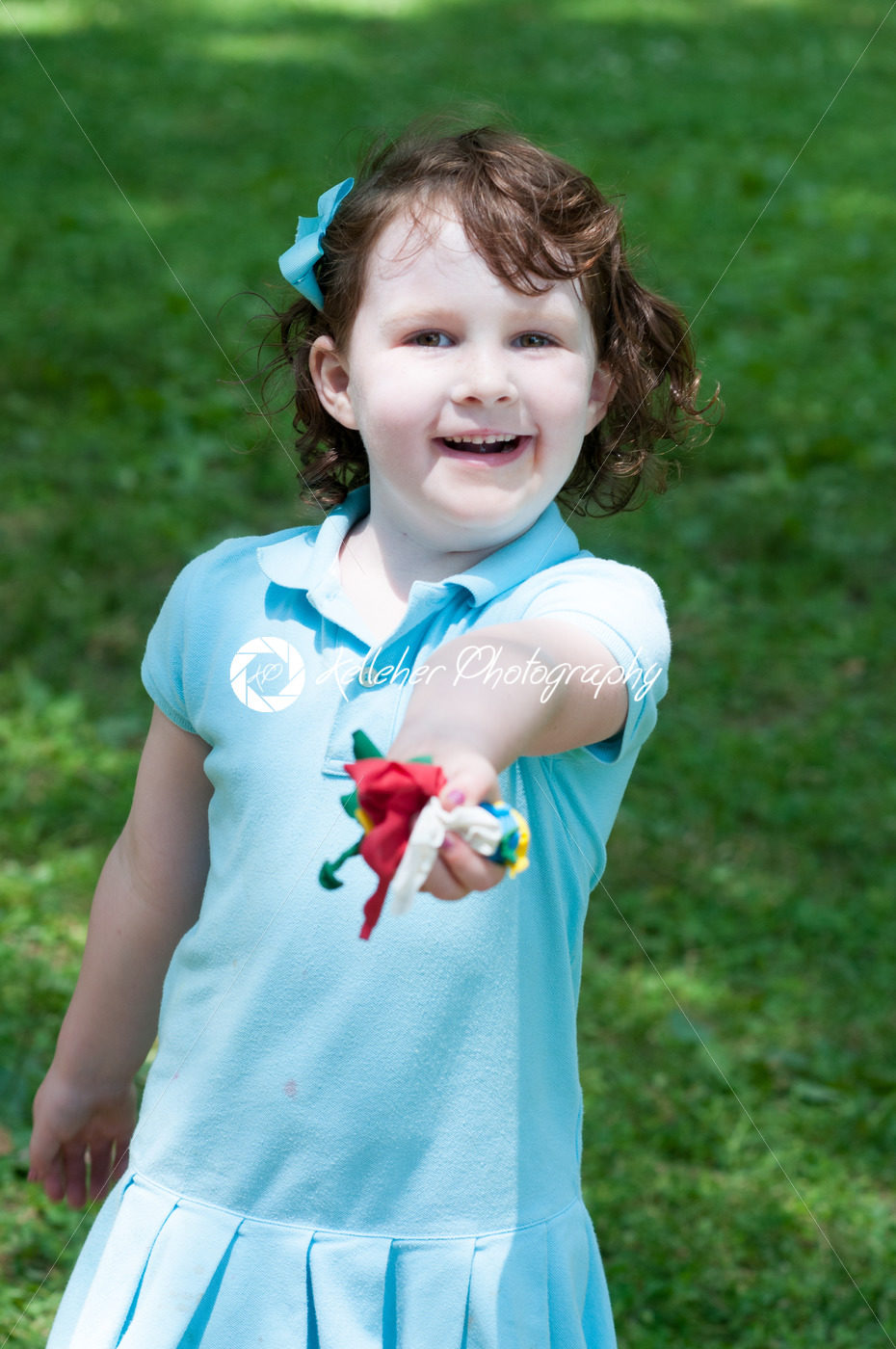 Young girl outside at park holding balloons - Kelleher Photography Store
