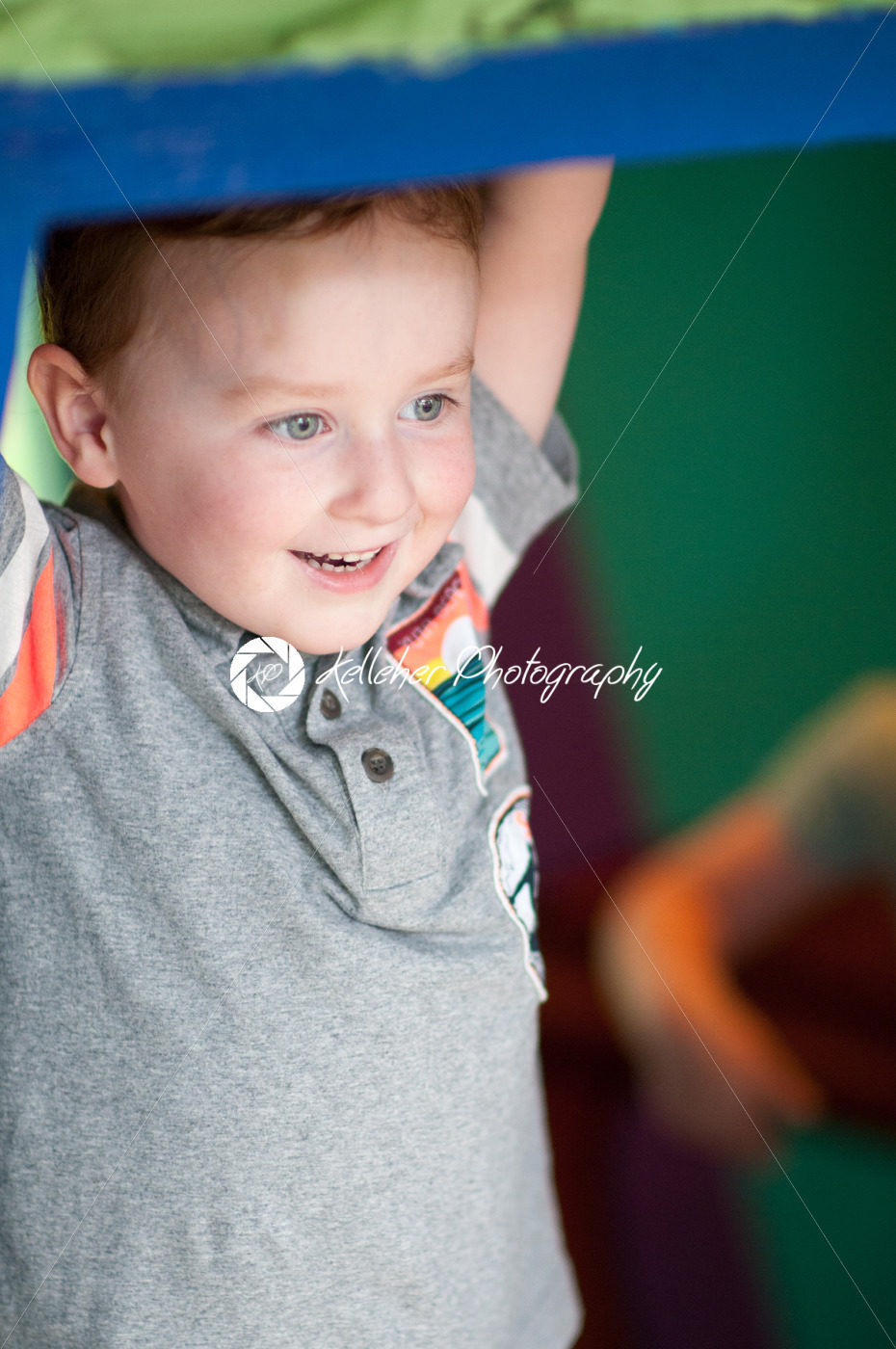 Young toddler boy having fun on boardwalk amusement ride - Kelleher Photography Store