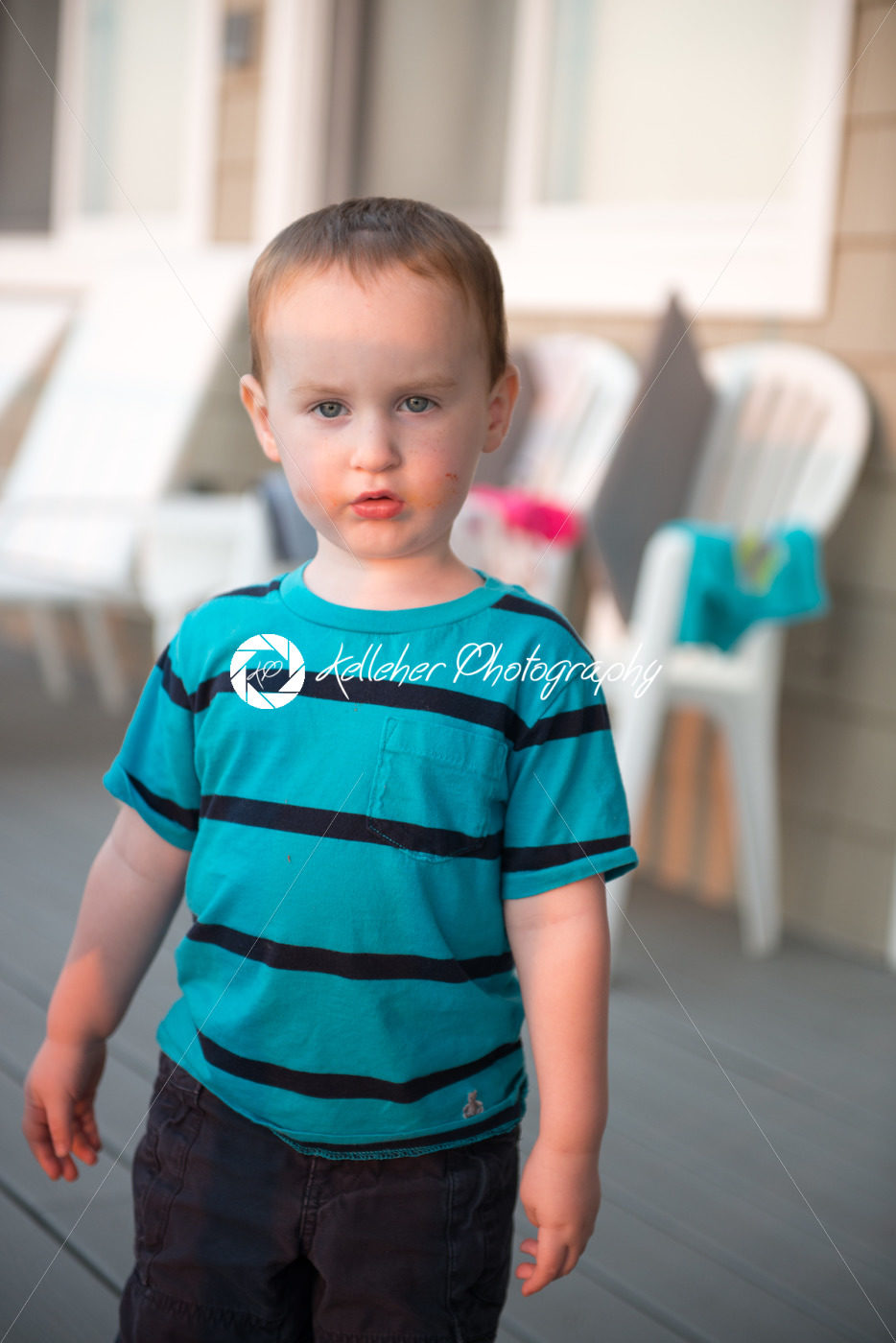 Young toddler boy on patio deck outside at sunset down at shore - Kelleher Photography Store