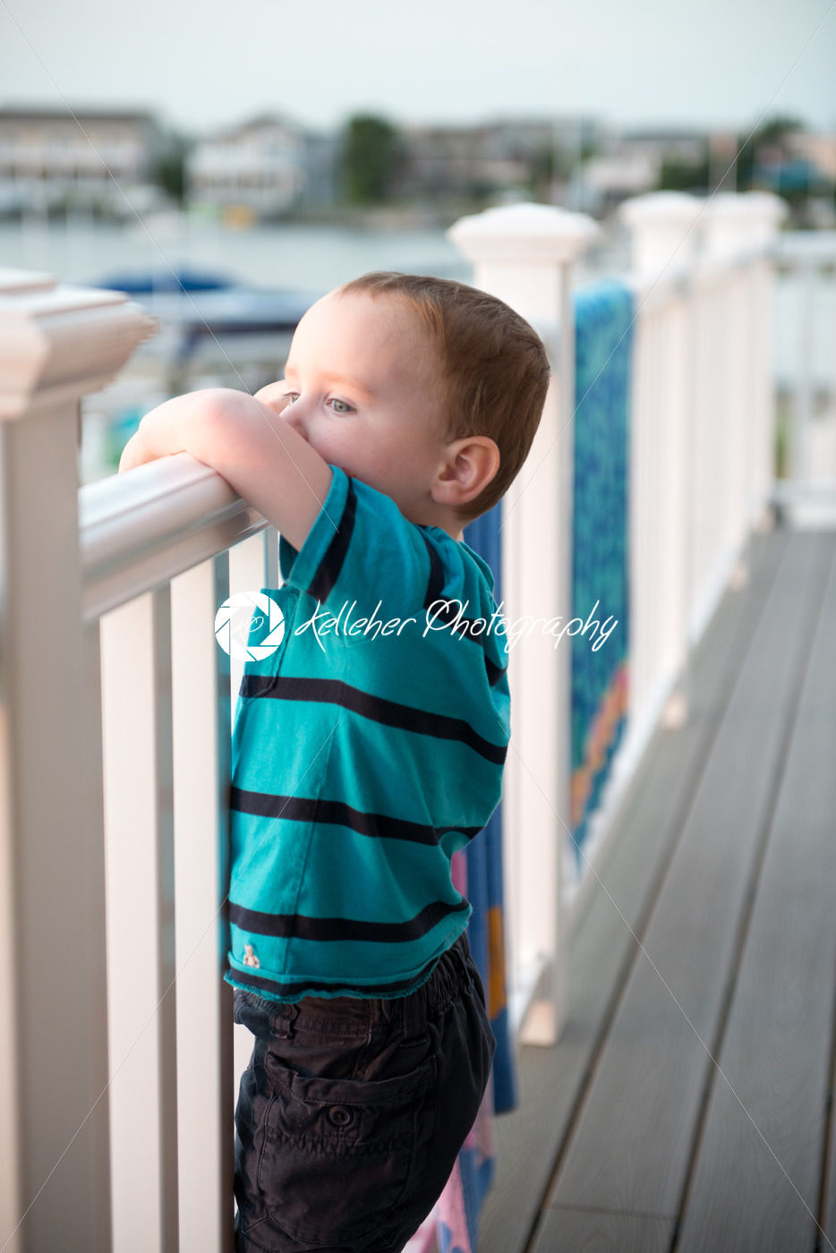 Young toddler boy on patio deck outside at sunset down at shore - Kelleher Photography Store