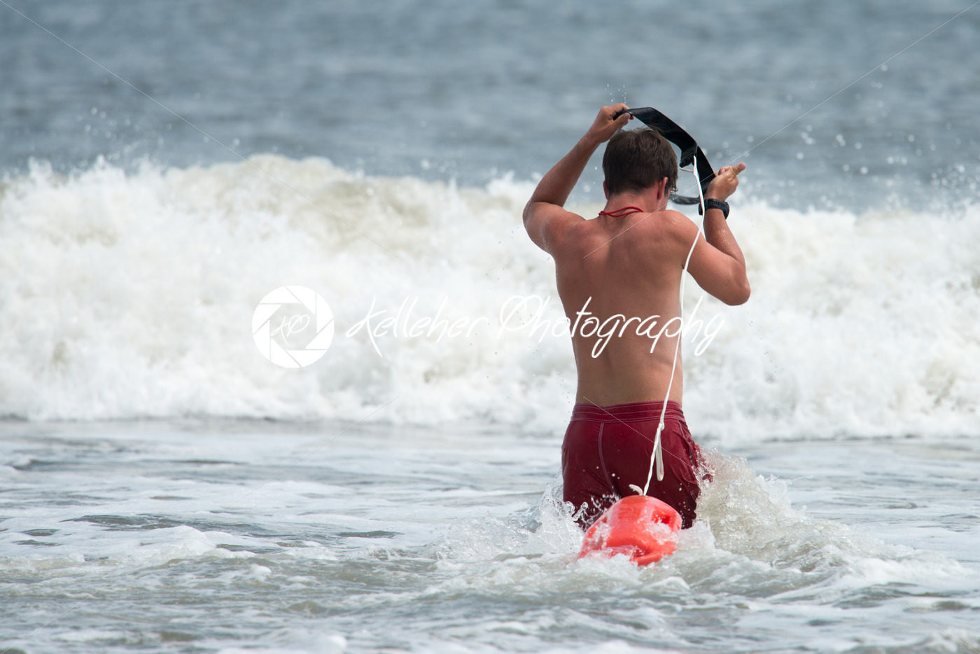 MARGATE CITY, NJ – AUGUST 8: Margate City Lifeguard running into the Atlantic Ocean to rescue a swimmer in distress - Kelleher Photography Store