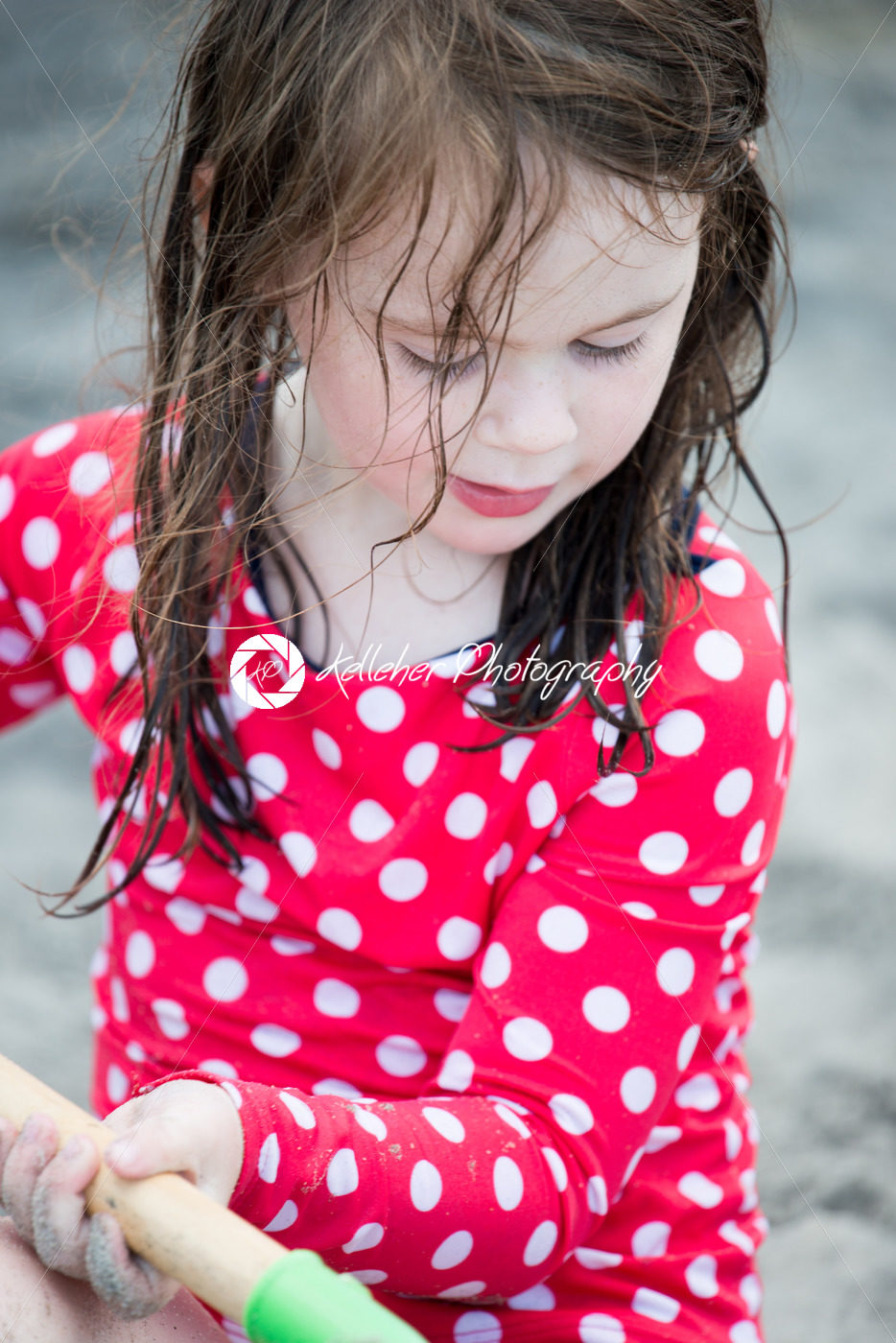 yound toddler girl having fun digging in the sand at the beach - Kelleher Photography Store