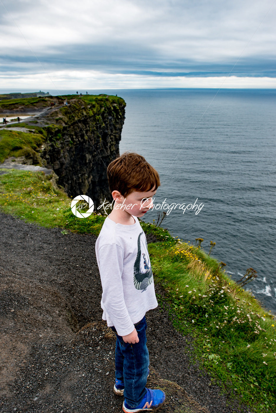 Boy looking out up the Cliffs of Moher Tourist Attraction in Ireland - Kelleher Photography Store