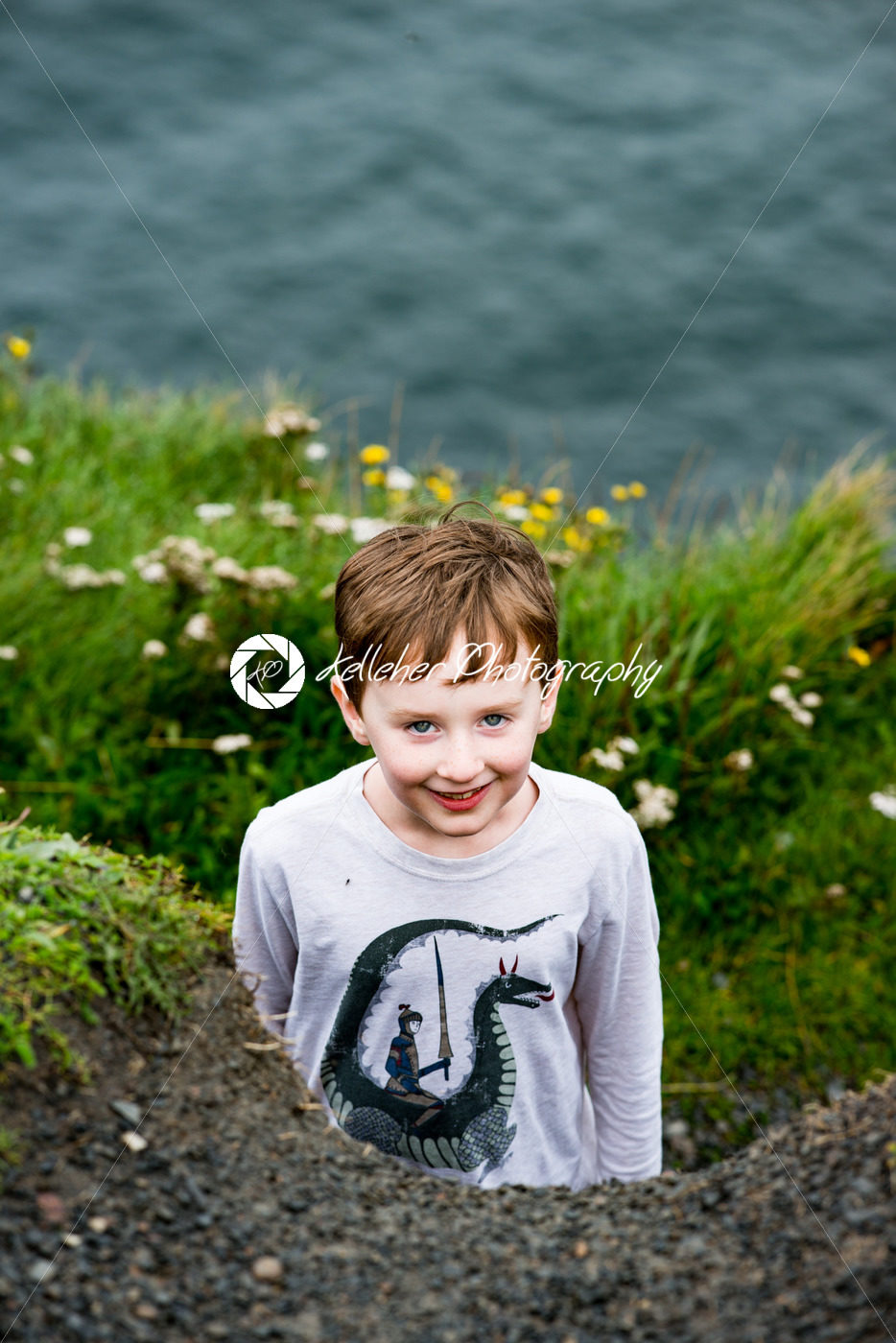 Boy looking up the Cliffs of Moher Tourist Attraction in Ireland - Kelleher Photography Store