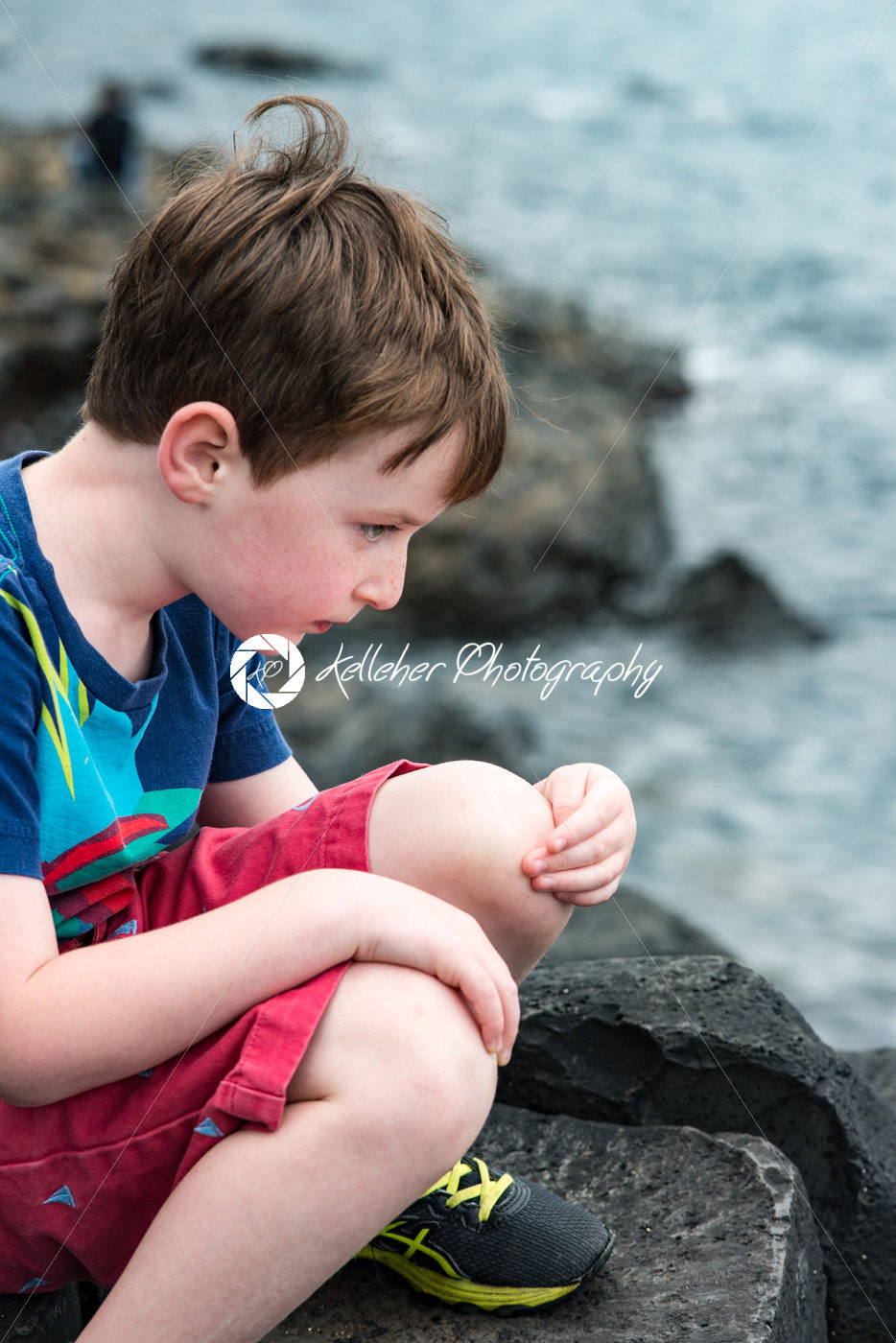 Boy sitting on the rocks at Giant’s Causeway - Kelleher Photography Store