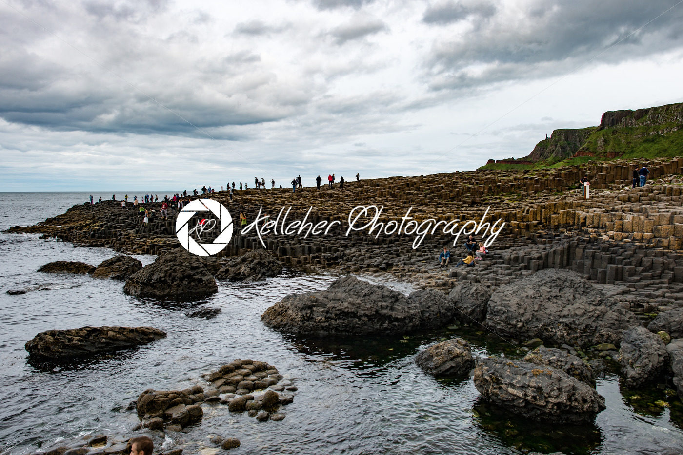 COUNTY ANTRIM, NORTHERN IRELAND – AUGUST 27, 2017: Group of tourists exploring the Giant’s Causeway - Kelleher Photography Store