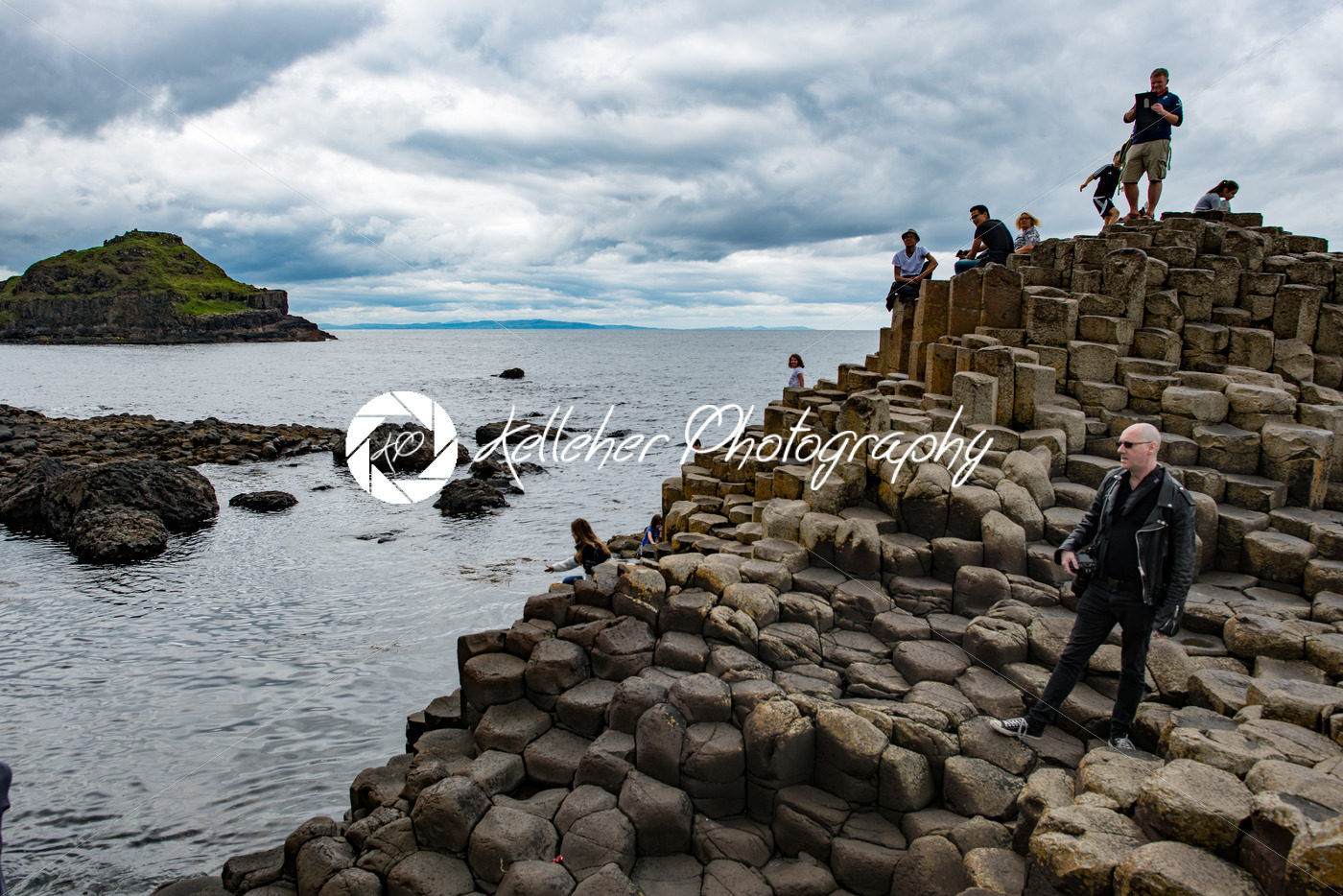 COUNTY ANTRIM, NORTHERN IRELAND – AUGUST 27, 2017: Group of tourists exploring the Giant’s Causeway - Kelleher Photography Store