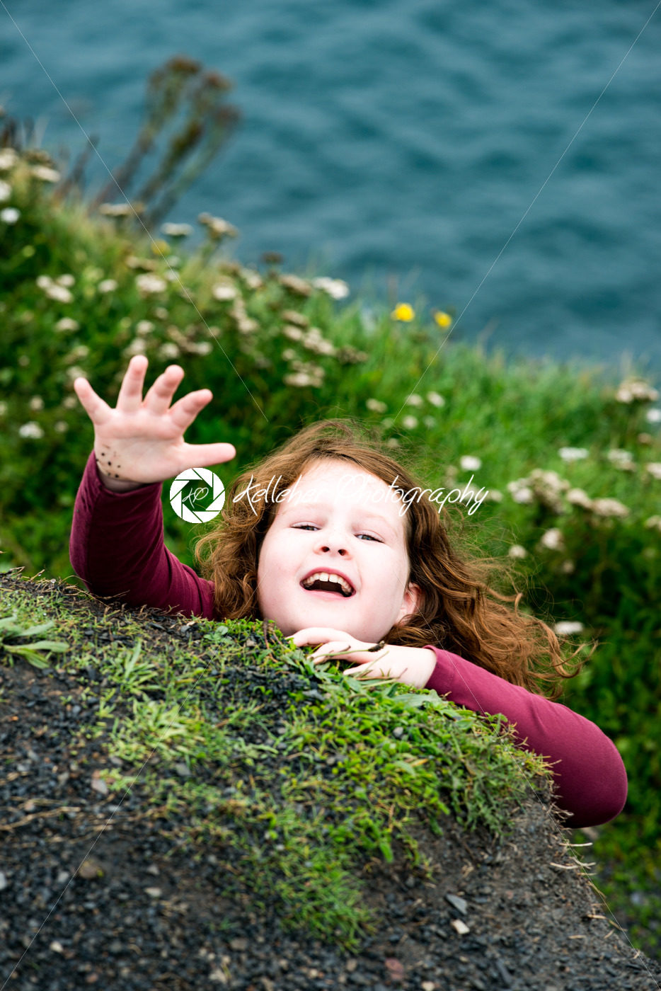 Girl looking up the Cliffs of Moher Tourist Attraction in Ireland - Kelleher Photography Store